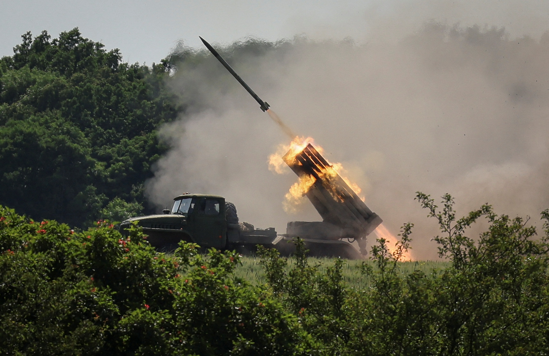 Ukrainian service members fire a BM-21 Grad multiple rocket launch system, near the town of Lysychansk, Luhansk region
