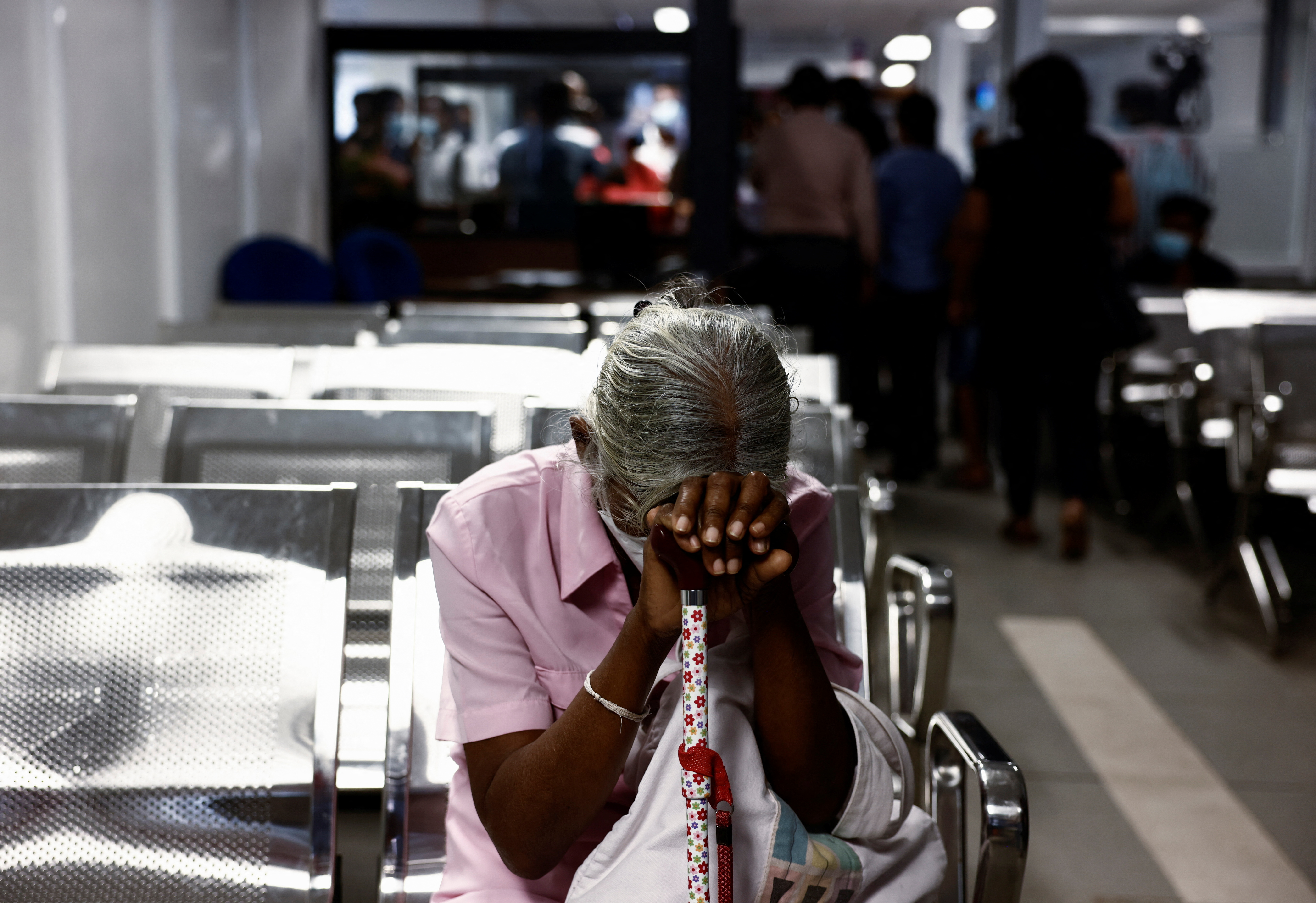 A woman waits to apply for a passport