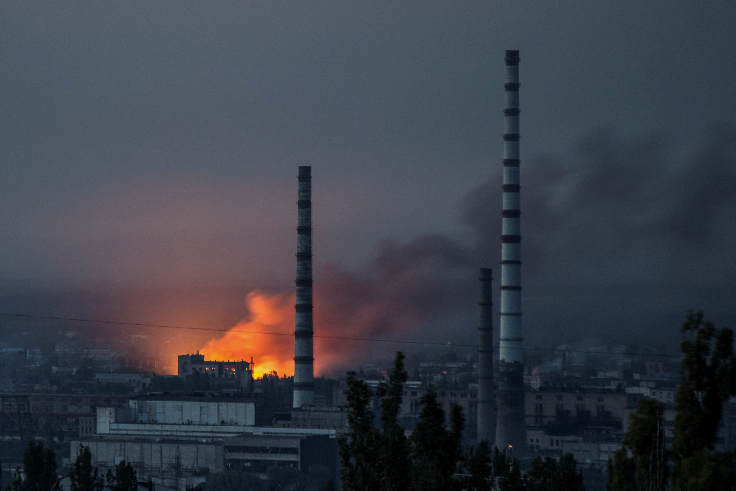 Smoke and flame rise after a military strike on a compound of Sievierodonetsk's Azot Chemical Plant, as Russia's attack on Ukraine continues, in Lysychansk, Luhansk region, Ukraine June 18, 2022.