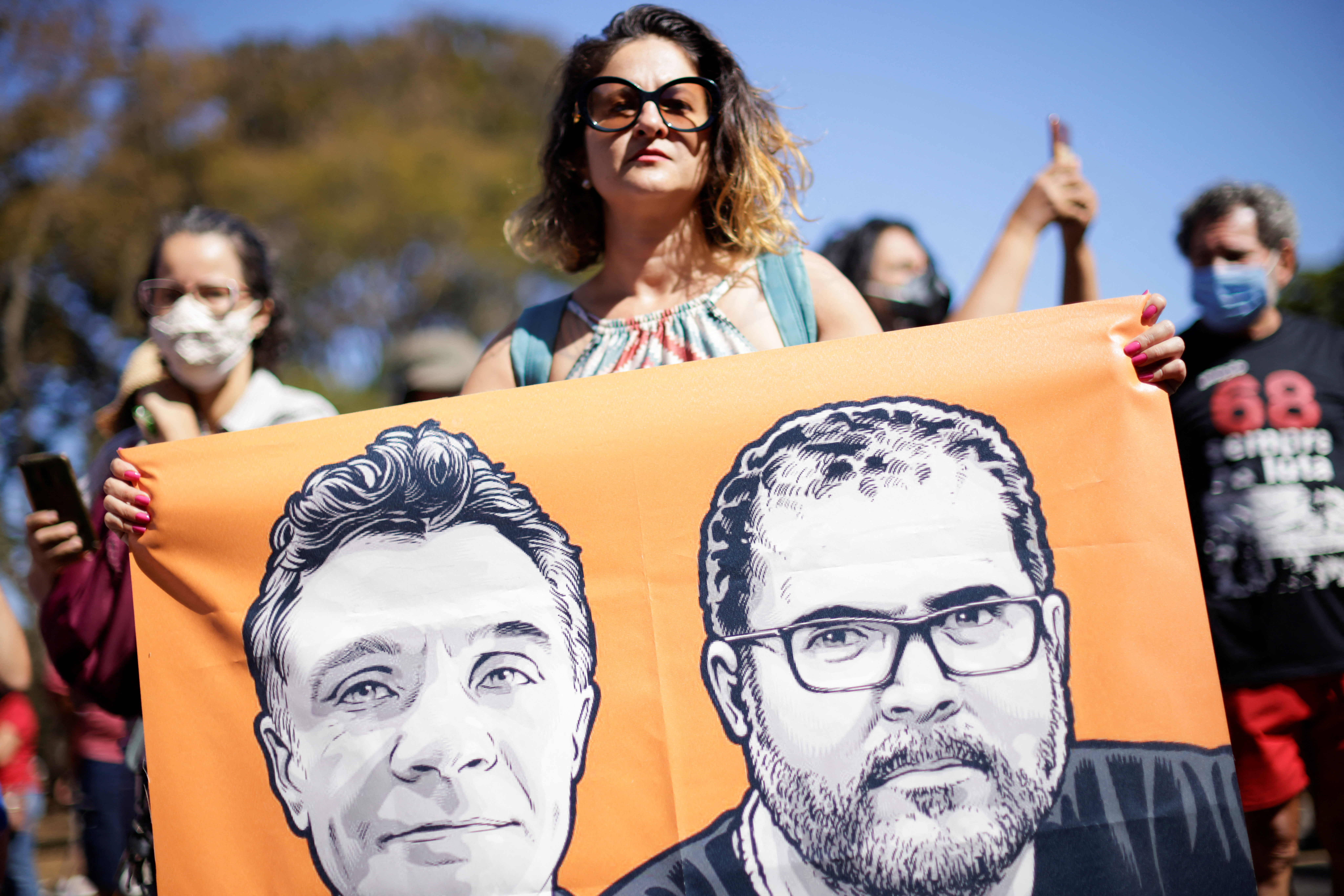 A woman holds a sign while taking part in a protest, to demand justice for journalist Dom Phillips and indigenous expert Bruno Pereira, who were murdered in the Amazon, in Brasilia, Brazil.