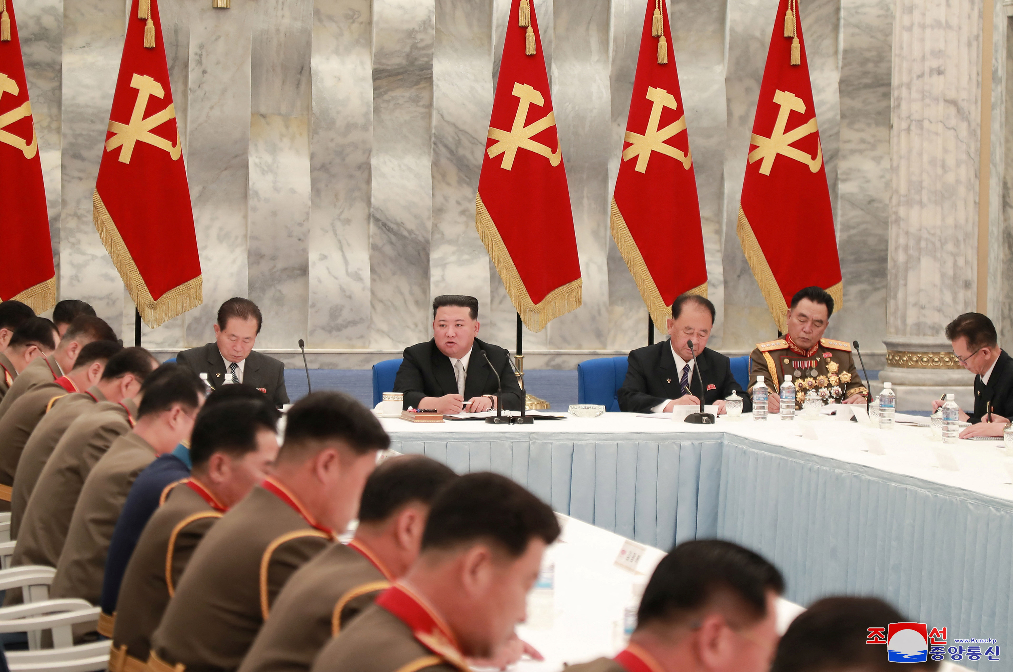 Kim Jong Un in a meeting with other officials.
