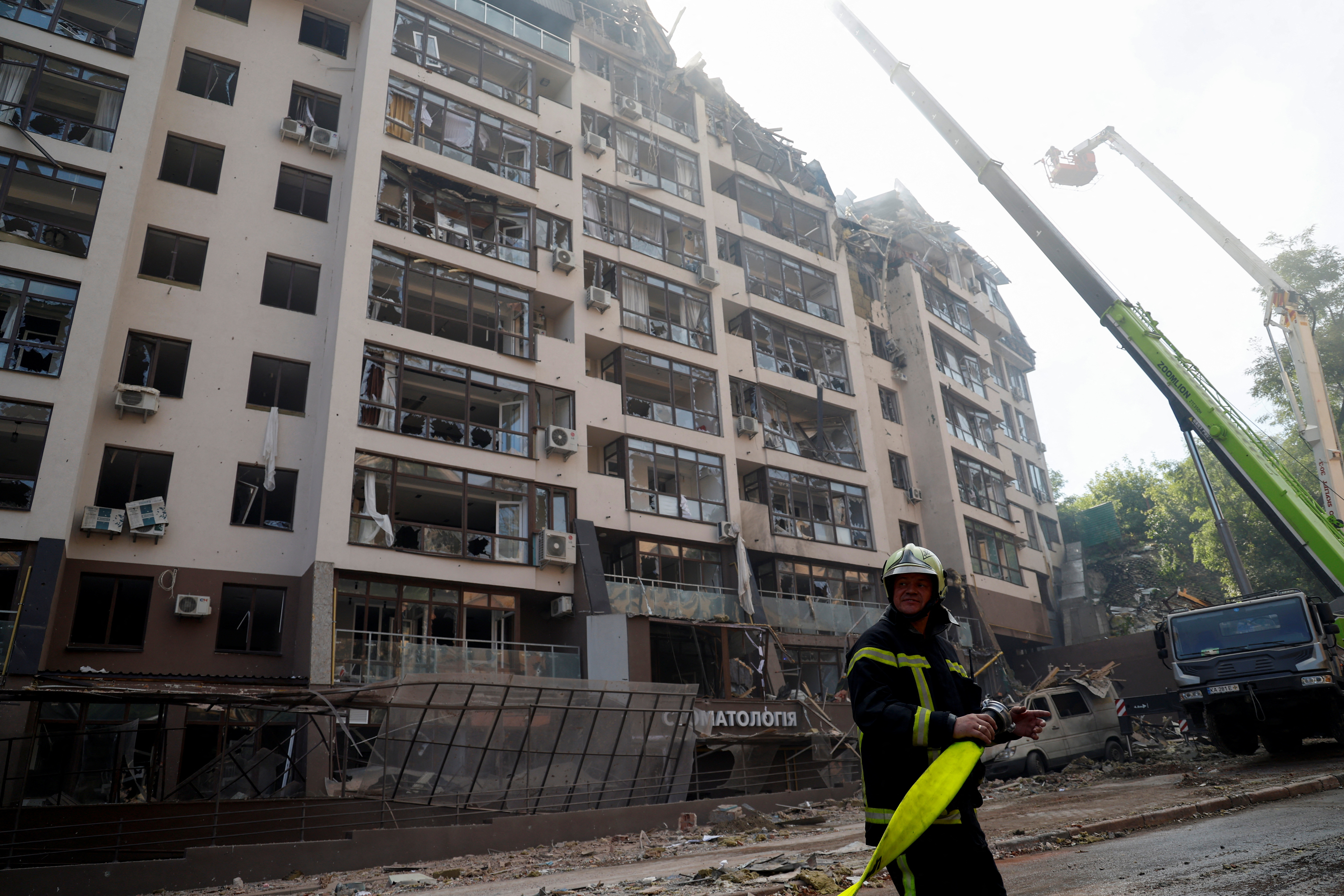 A firefighter works at a residential building damaged by a Russian missile strike, as Russia's attack on Ukraine continues, in Kyiv.