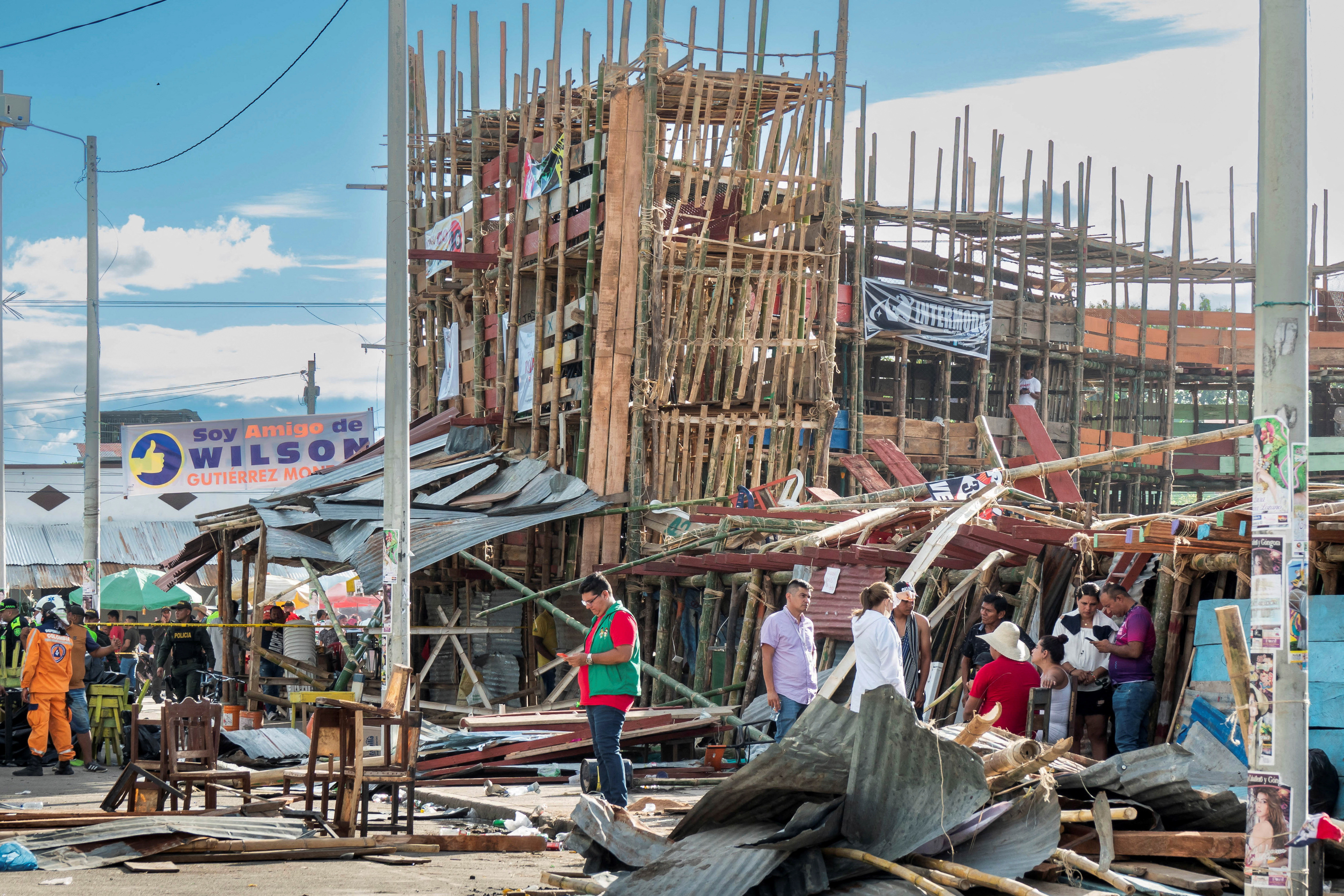 Residents gather near the rubble of a grandstand after it collapsed in a bullring during the celebrations of the San Pedro festivities, in El Espinal, Colombia.