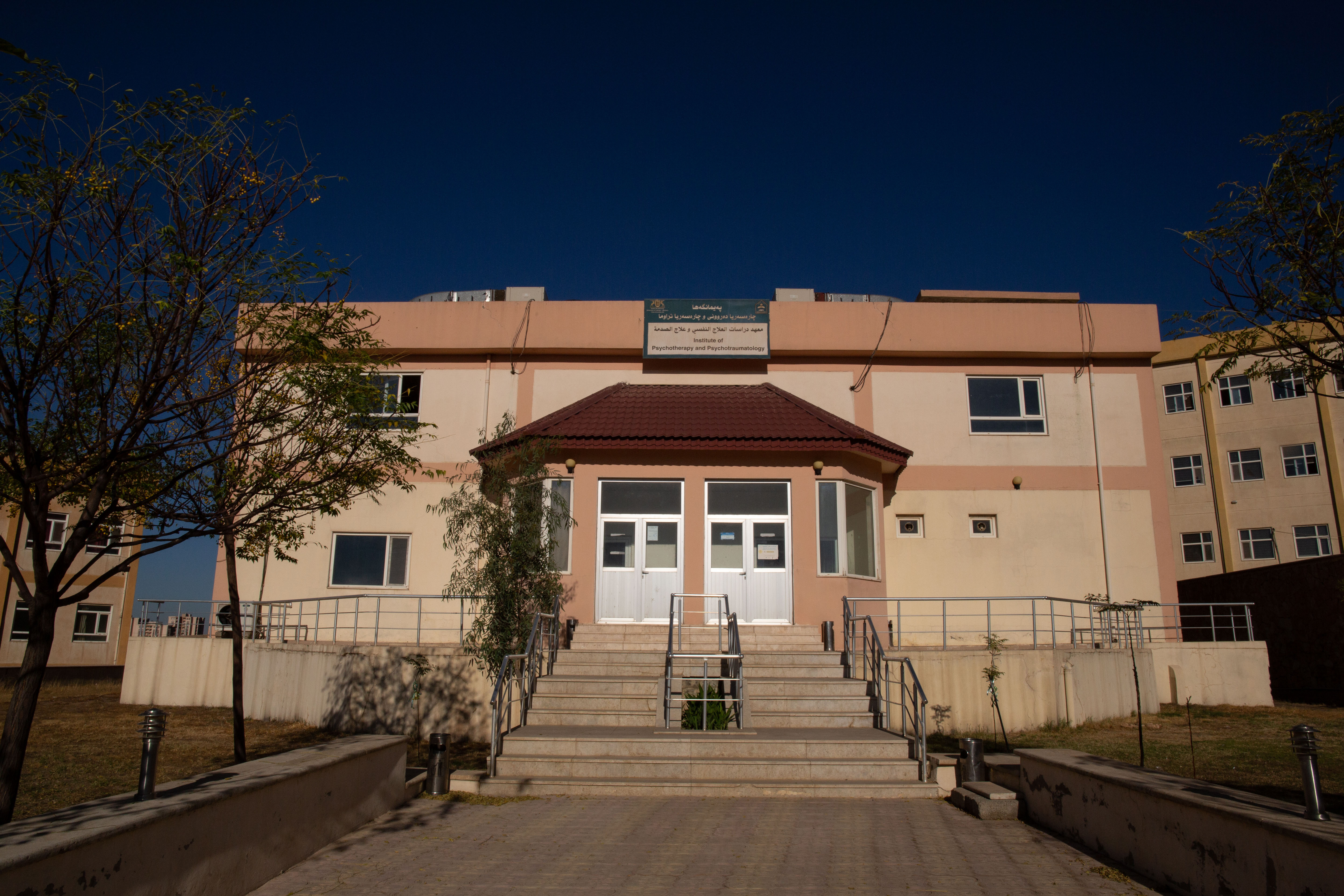 A photo of a building with two doors in front.