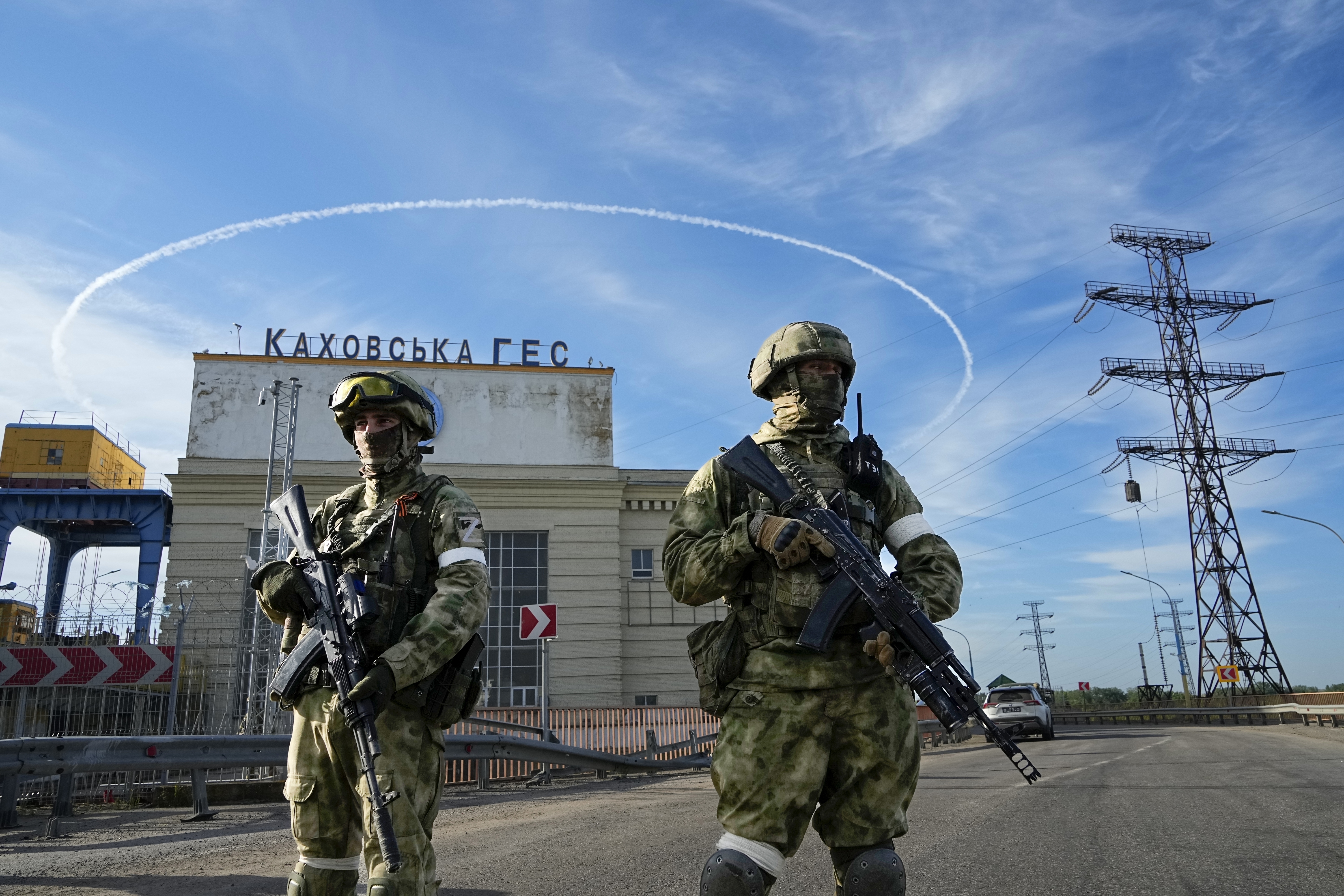 Russian troops guard an entrance of the Kakhovka Hydroelectric Station, a run-of-the-river power plant on the Dnieper River in Kherson region