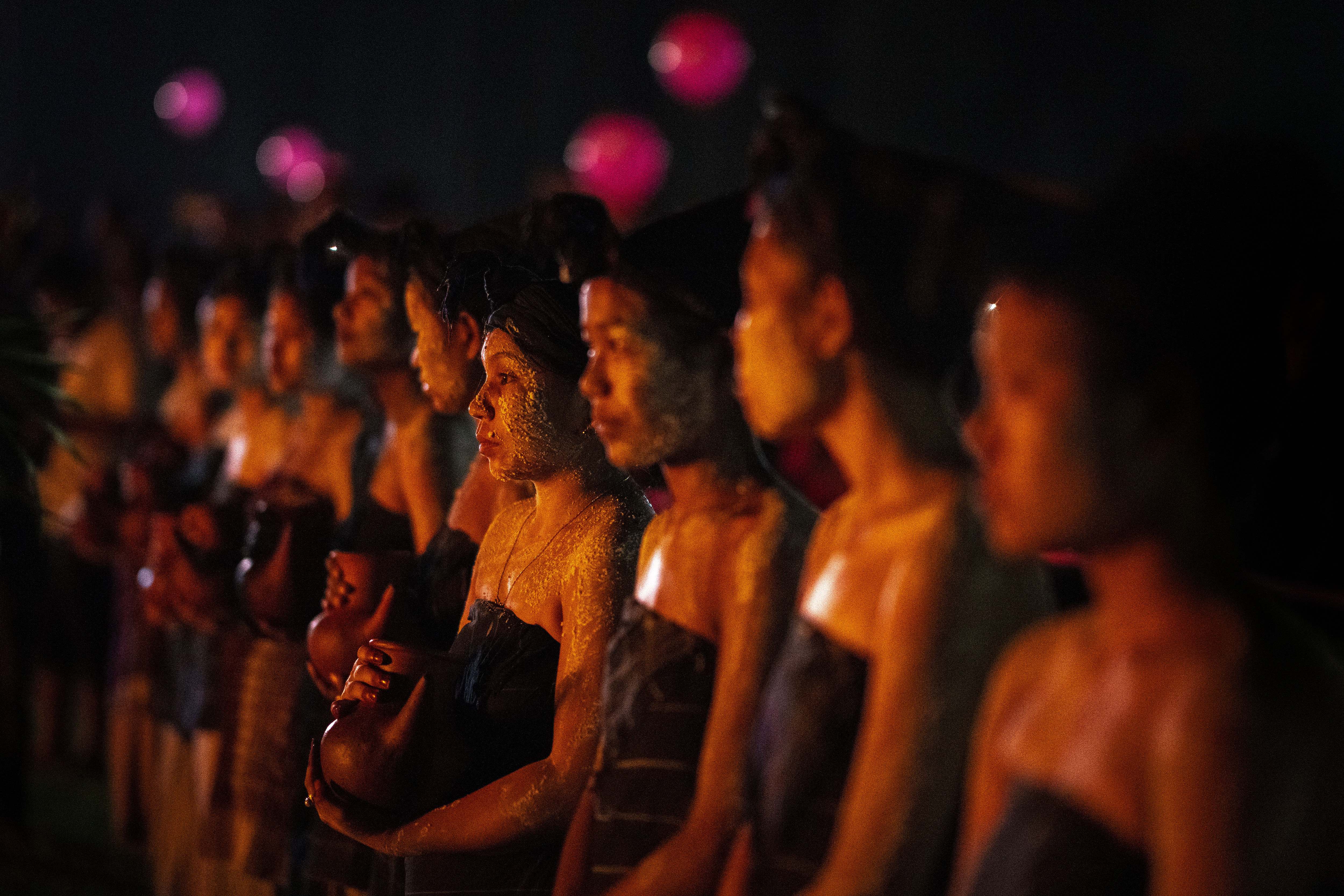 Rabha tribal girls in traditional attire hold earthen pots filled with traditional rice beer to serve Rabha Hindu