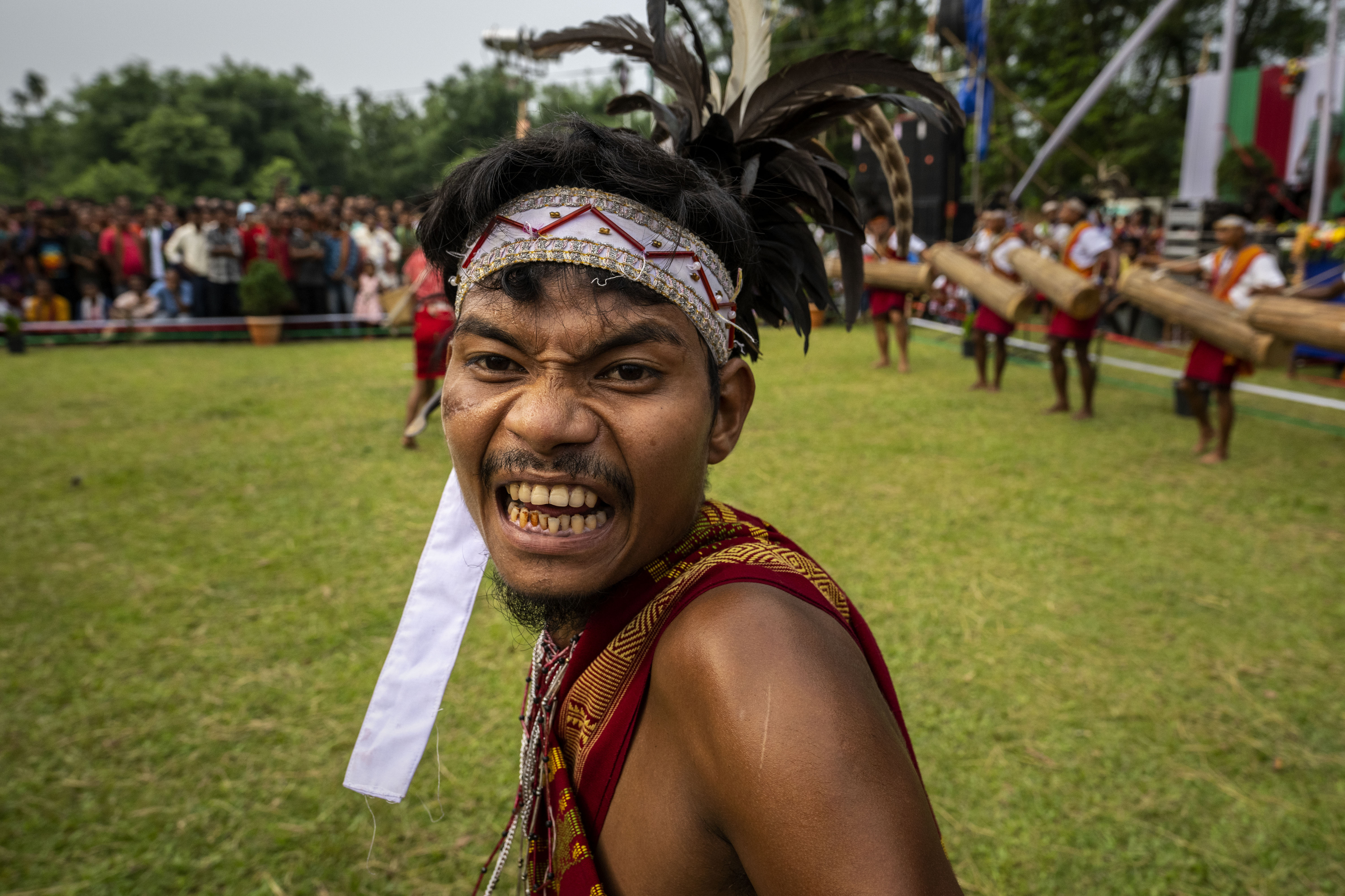 An Indian Garo tribal in traditional attire performs a traditional dance during Baikho festival