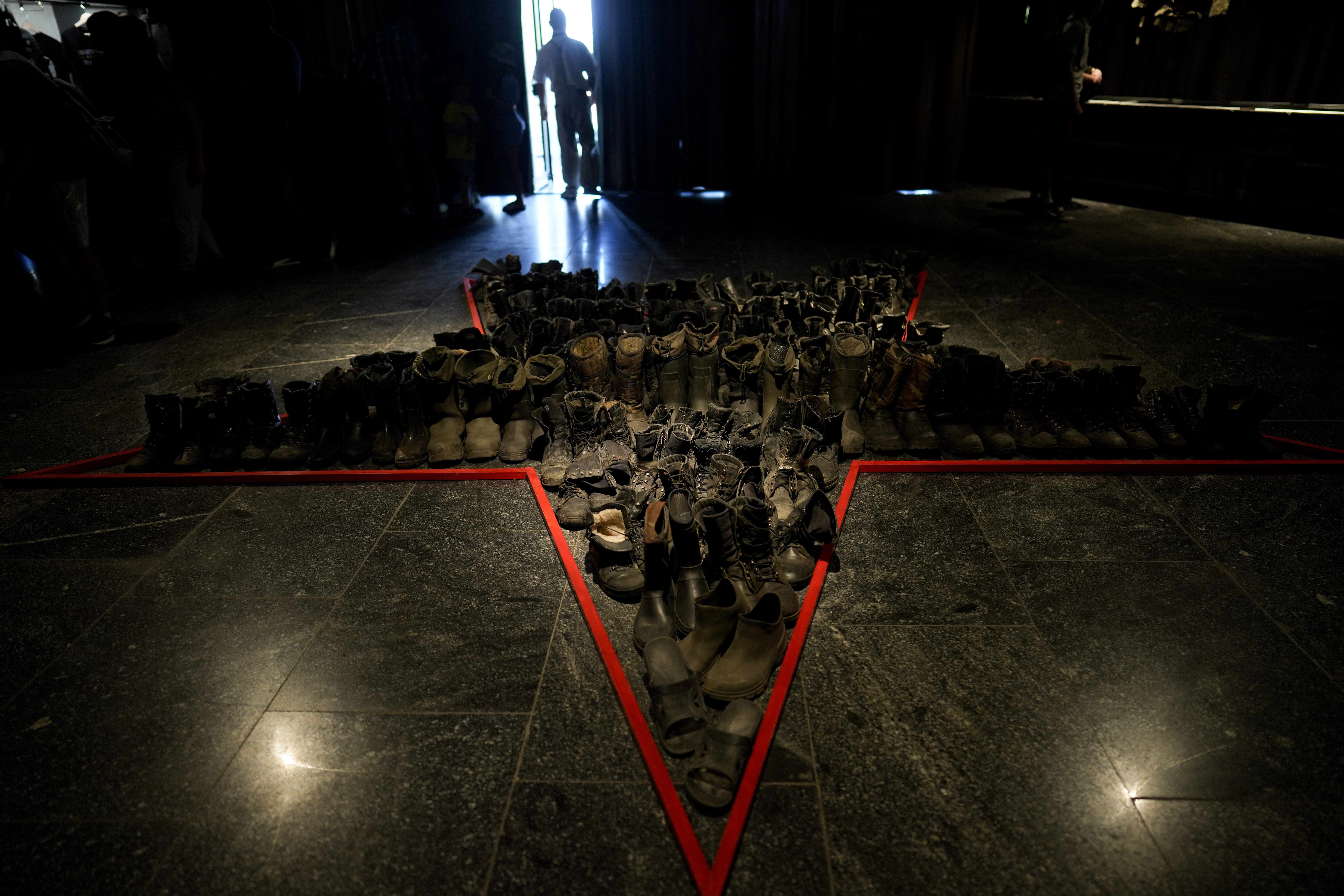 Russian boots are displayed at an exhibition in Kyiv, Ukraine.
