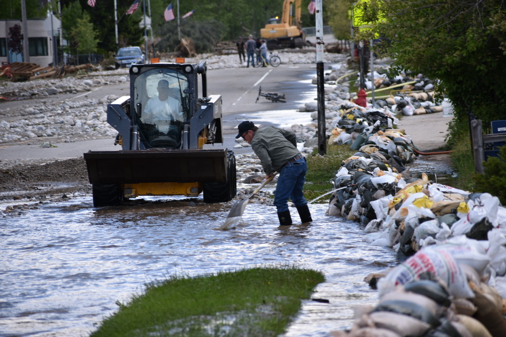 Residents of Red Lodge, Montana, are seen clearing mud, water and debris from the small city's main street