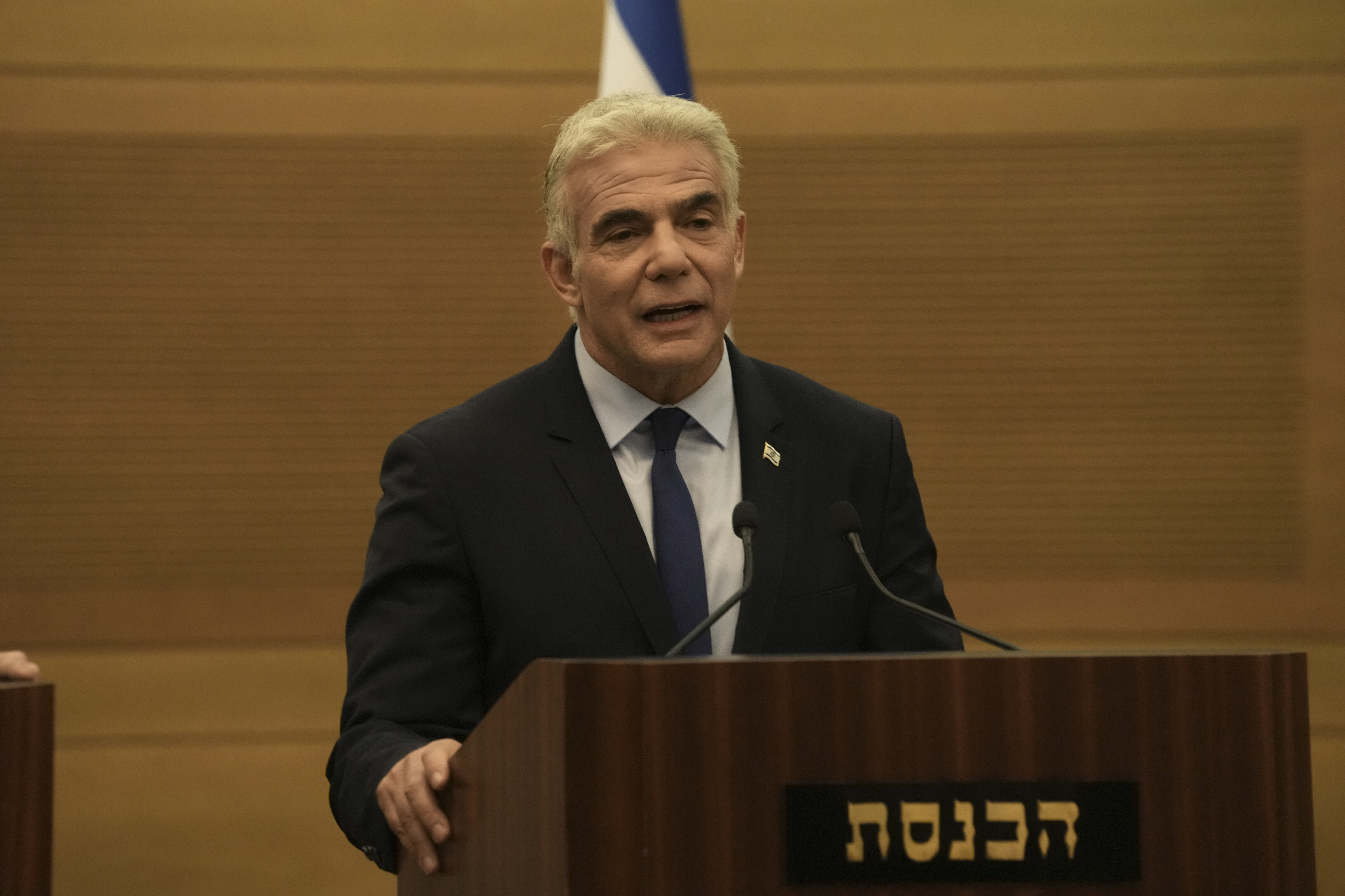 Israeli Foreign Minister Yair Lapid speaks during a joint statement with Prime Minister Naftali Bennett, at the Knesset, Israel's parliament, in Jerusalem, June 20, 2022