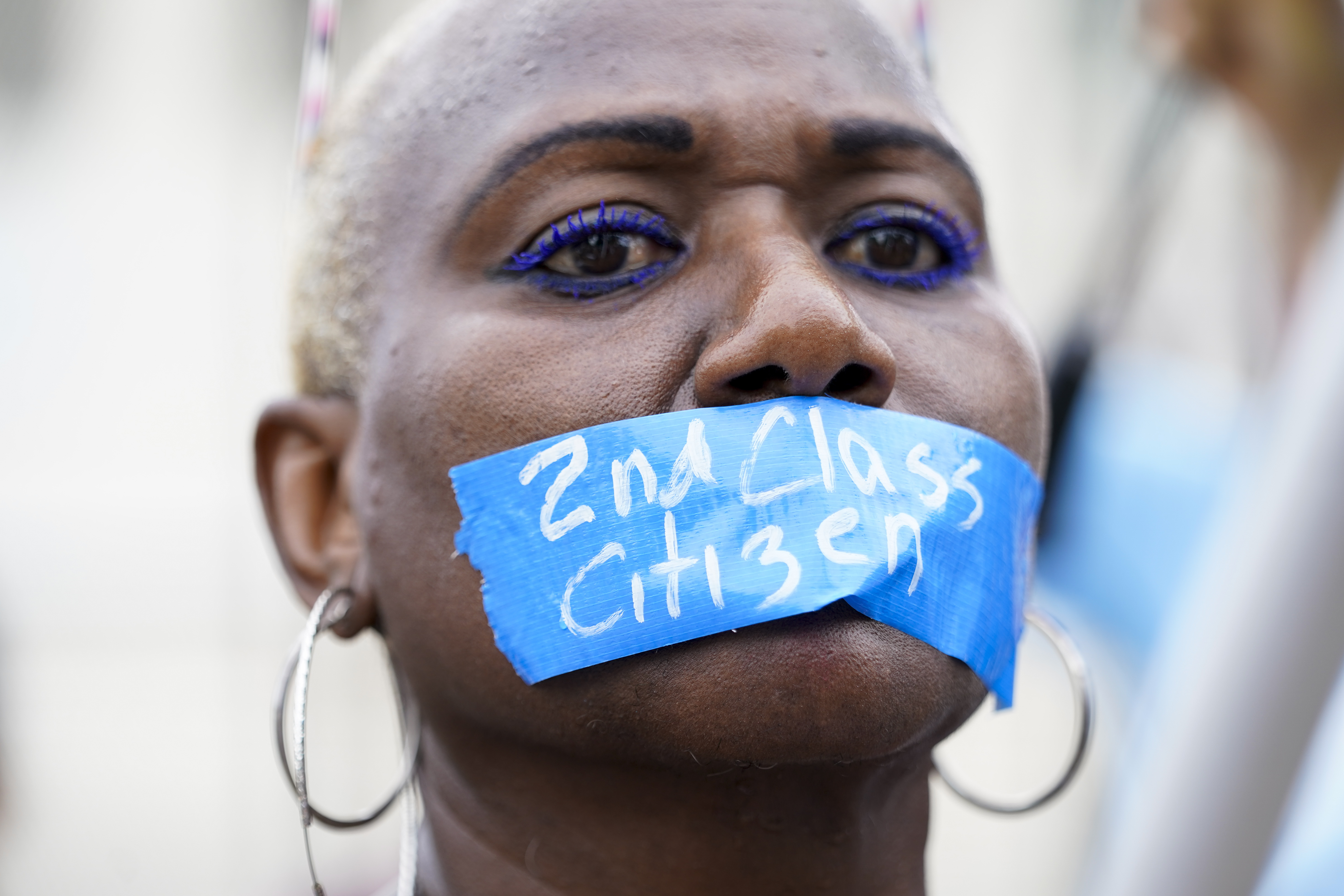 An abortion-rights activist wears tape reading "2nd Class Citizen" on their mouth as they protest outside the Supreme Court in Washington DC, on June 24, 2022 [Jacquelyn Martin/AP]
