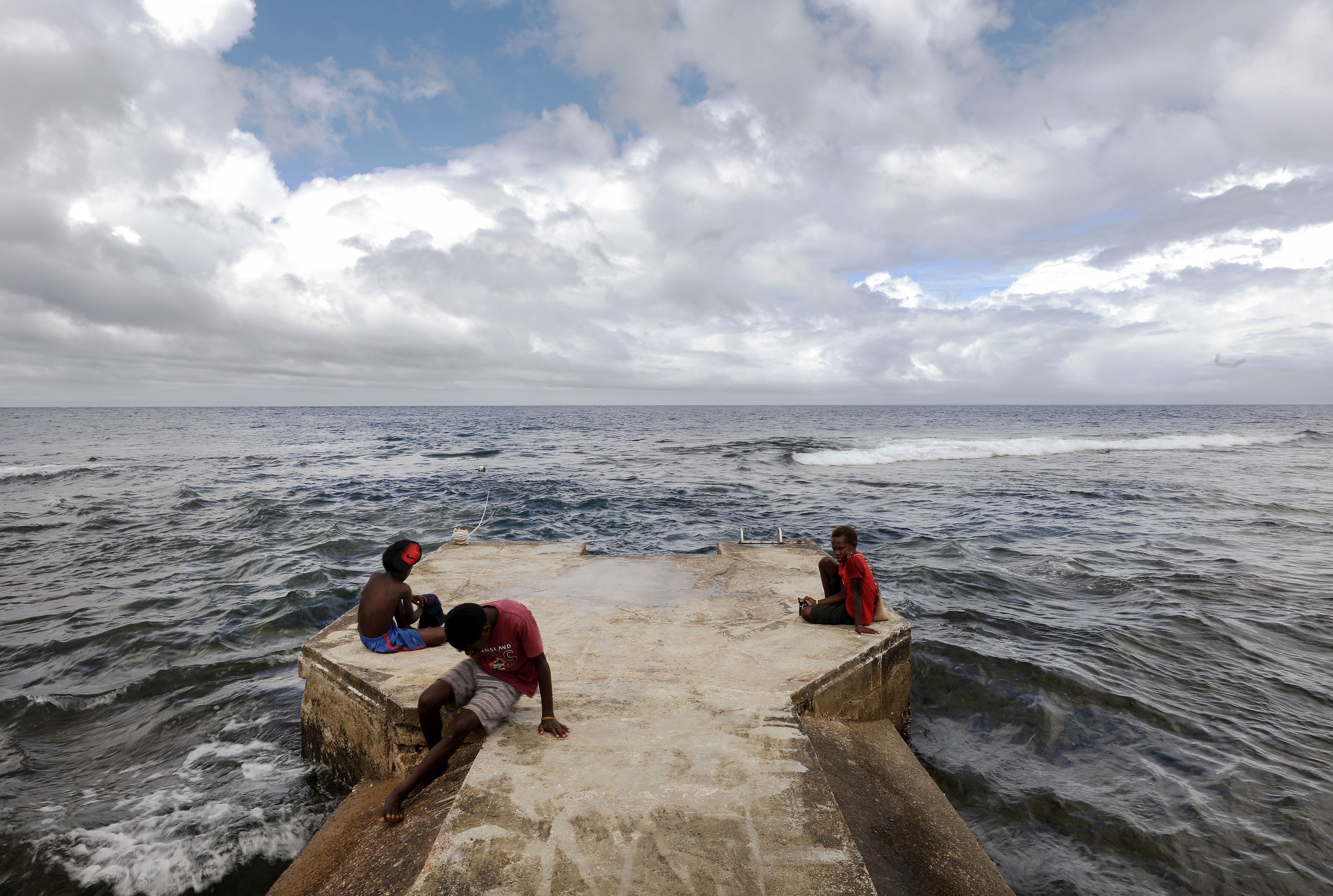 People gather on a pier in Tanna, Vanuatu.