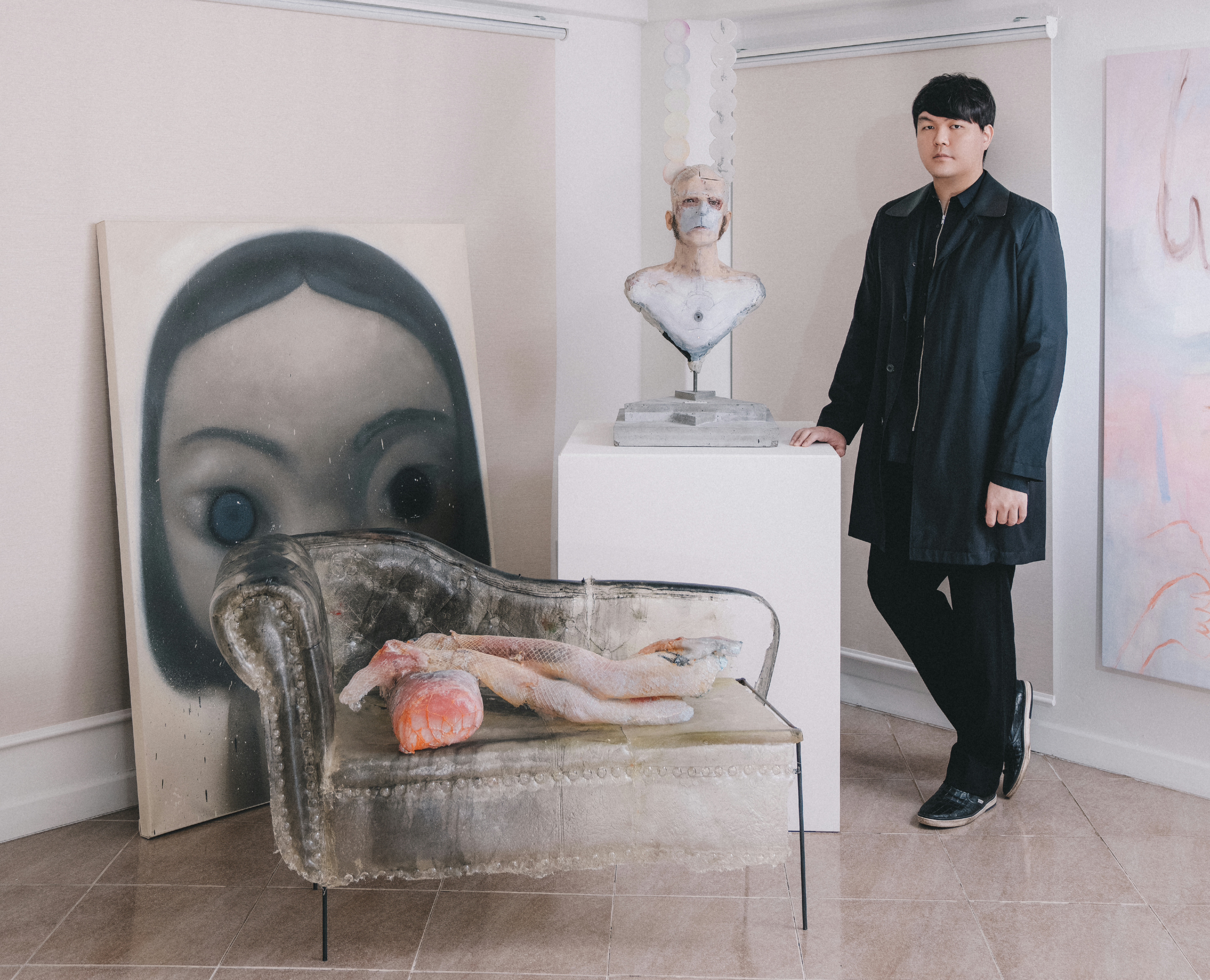 Jae-myung Noh posing with artwork.