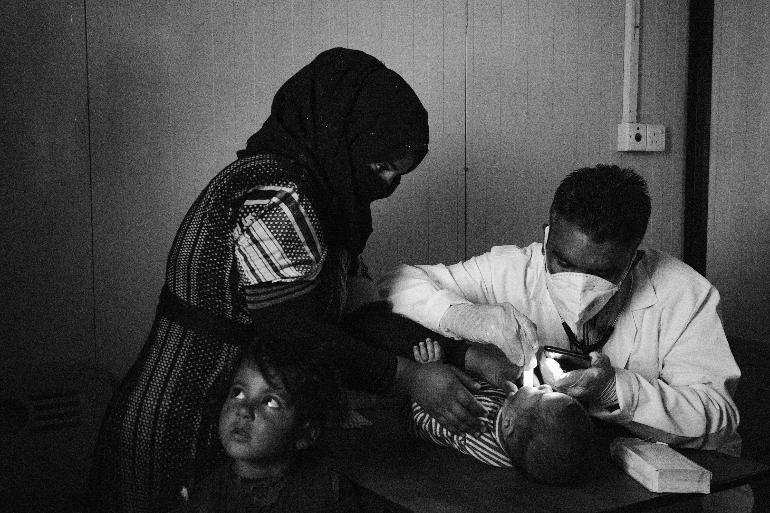 In a remote village south of Tal Afar, a doctor of the NGO Intersos visits a baby inside one of the mobile clinics with which the organization provides basic health services.
