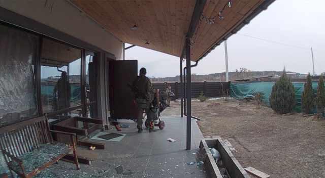 A photo of a CCTV still of Russian soldiers looting the home capturing the CCTV footage in mid-March as seen from the backyard.