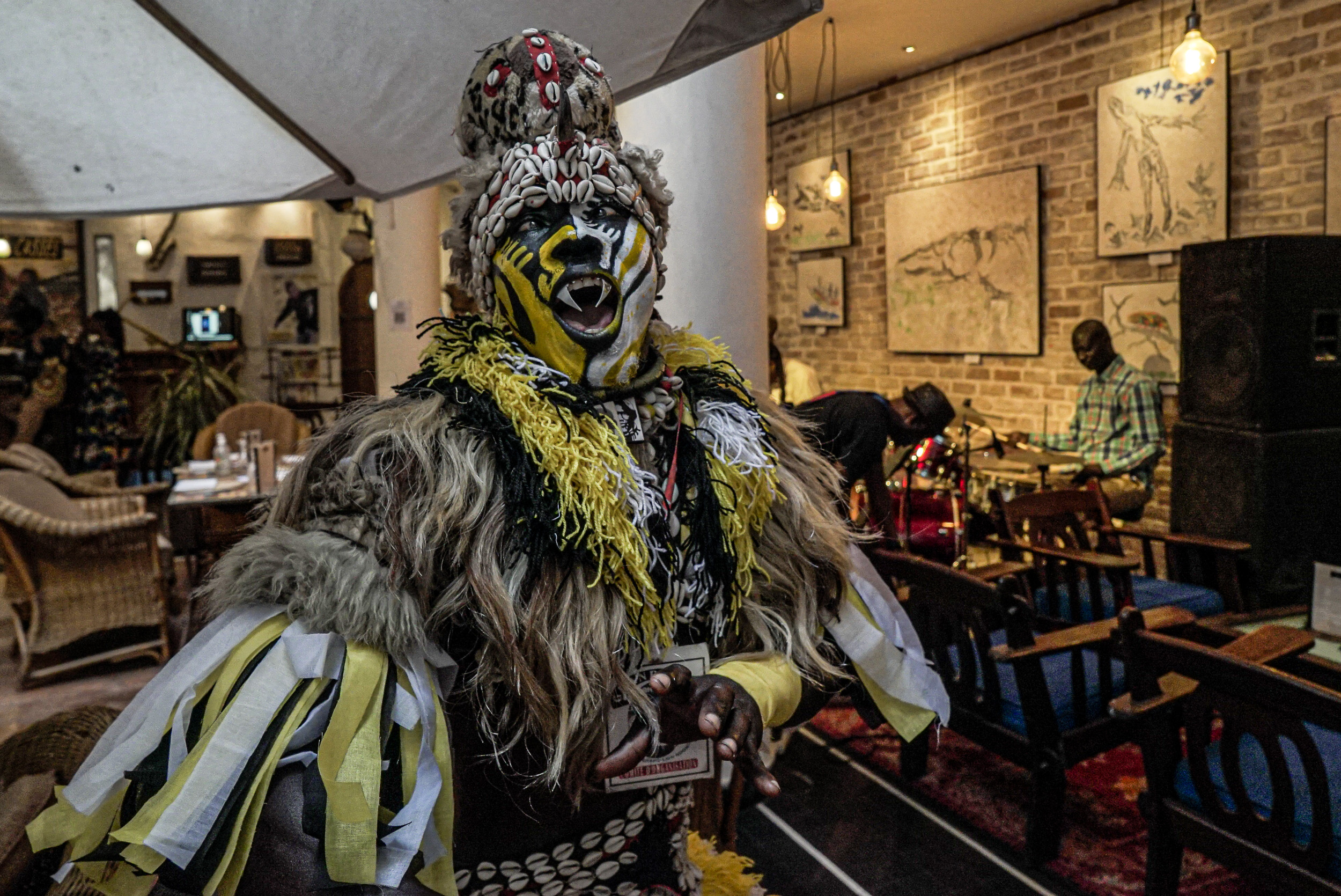 A street performer entertains tourists at Hotel de la Résidence during the Saint Louis Jazz Festival