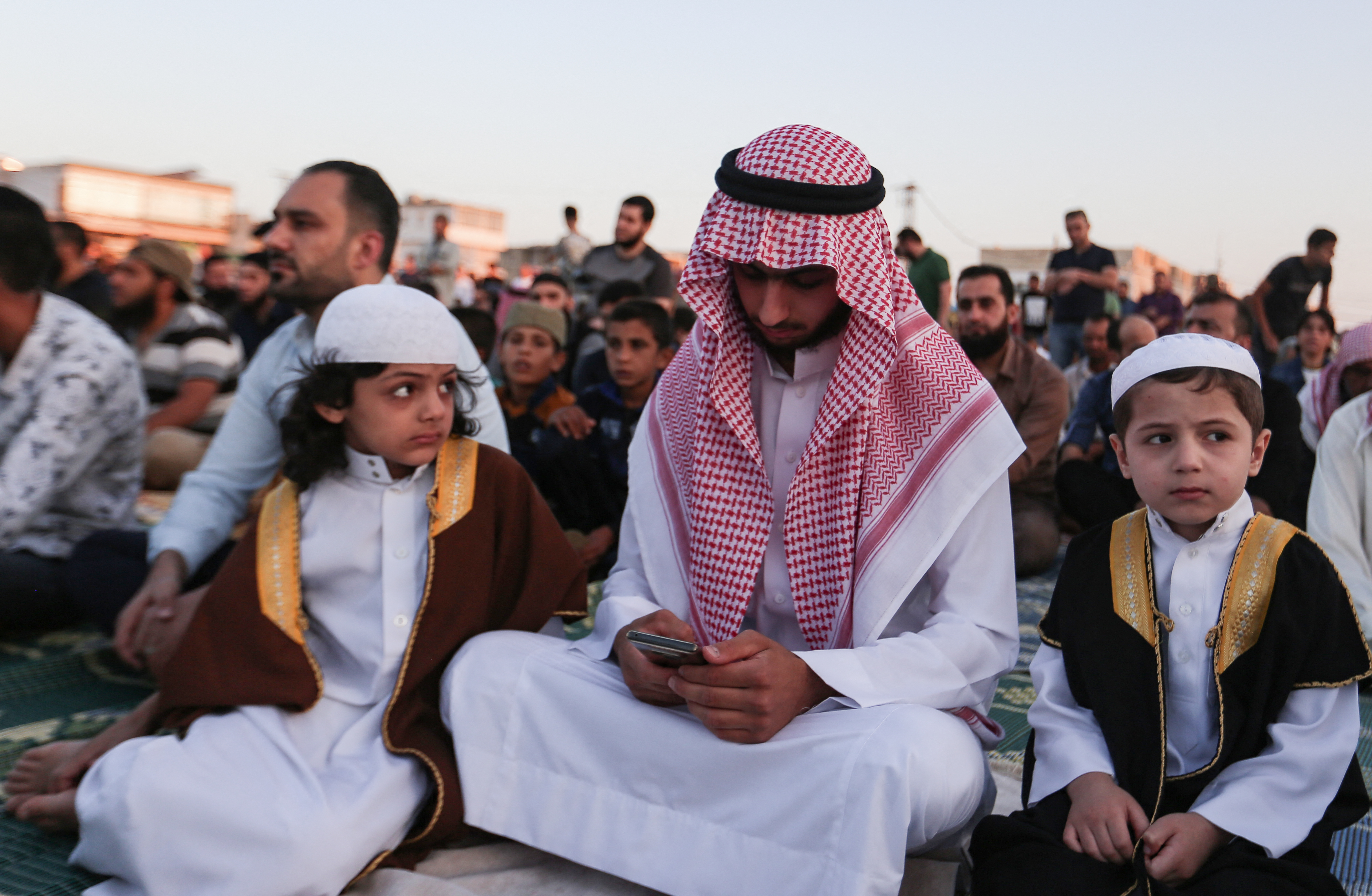 Muslims gather to perform the morning prayer in Bab al-Hawa near the border with Turkey, in Syria's northwestern Idlib province, on the Eid al-Adha holiday,