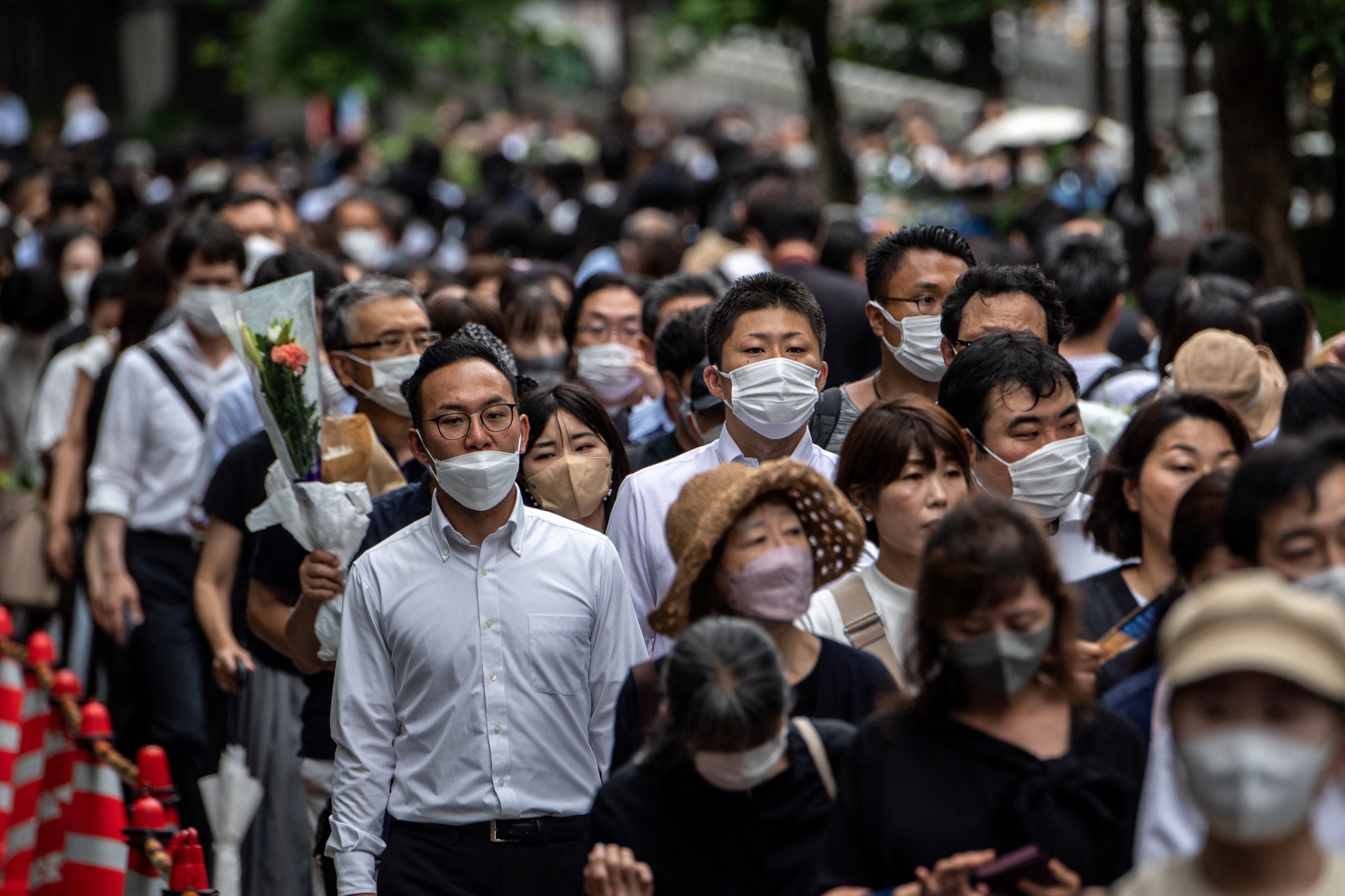 People offer flowers to late former Japanese prime minister Shinzo Abe at Zojoji Temple