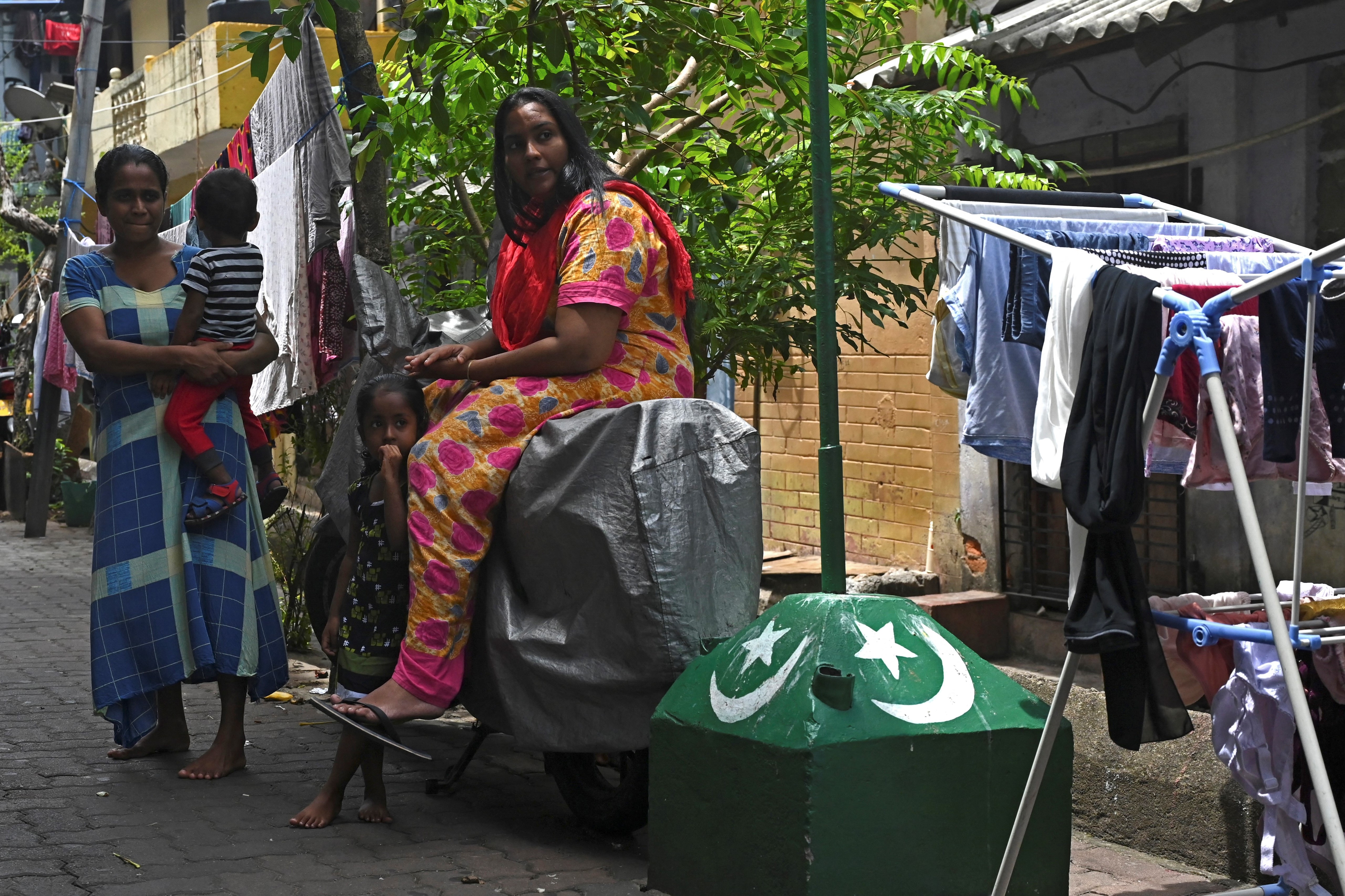 residents in an alleyway in the Slave Island