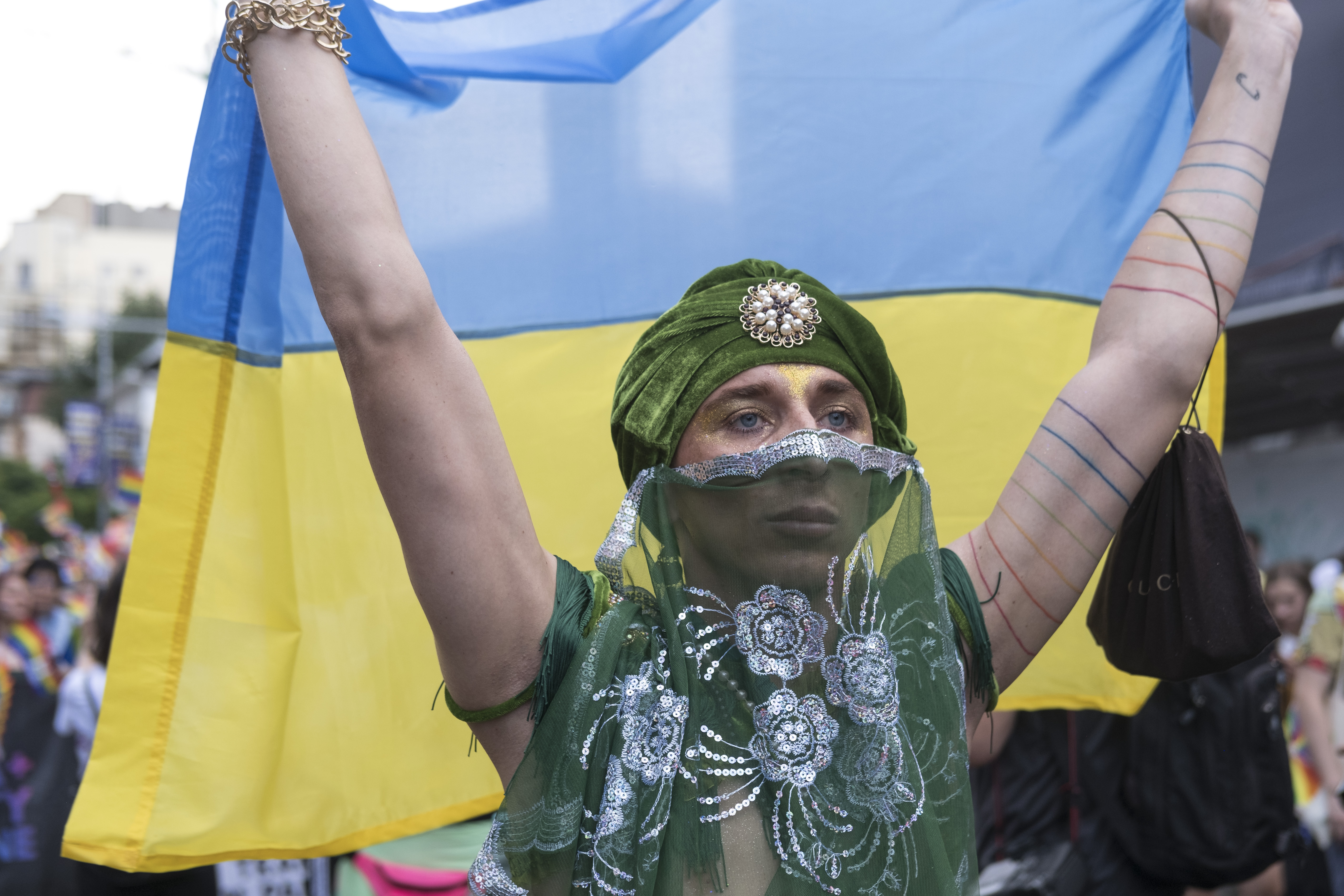 A Ukrainian dancer waved his national flag in a message against war during Bucharest Pride.