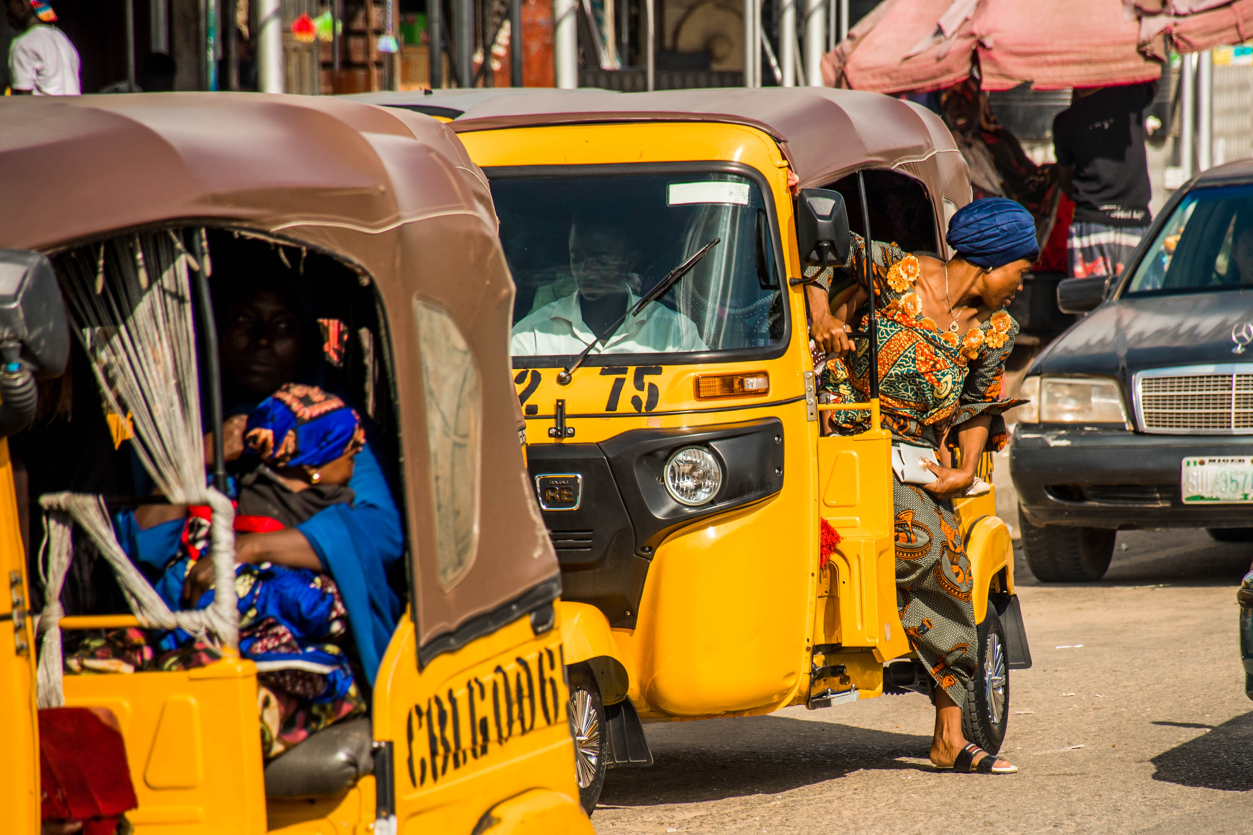 A female shopkeeper hails a taxi to take her to her shop. Transportation costs, security, and congestion remain major obstacles to getting people and goods from one city to the next in Northern Nigeria. Vendors l ike Bunmi admit this limits their access to quality inputs for the products they sell in their shops. “Some are not as good, like maybe traveling to Lagos, not as good as traveling to like outside these (Northern) states…it would be more expensive traveling to go and get them anywhere else.”
