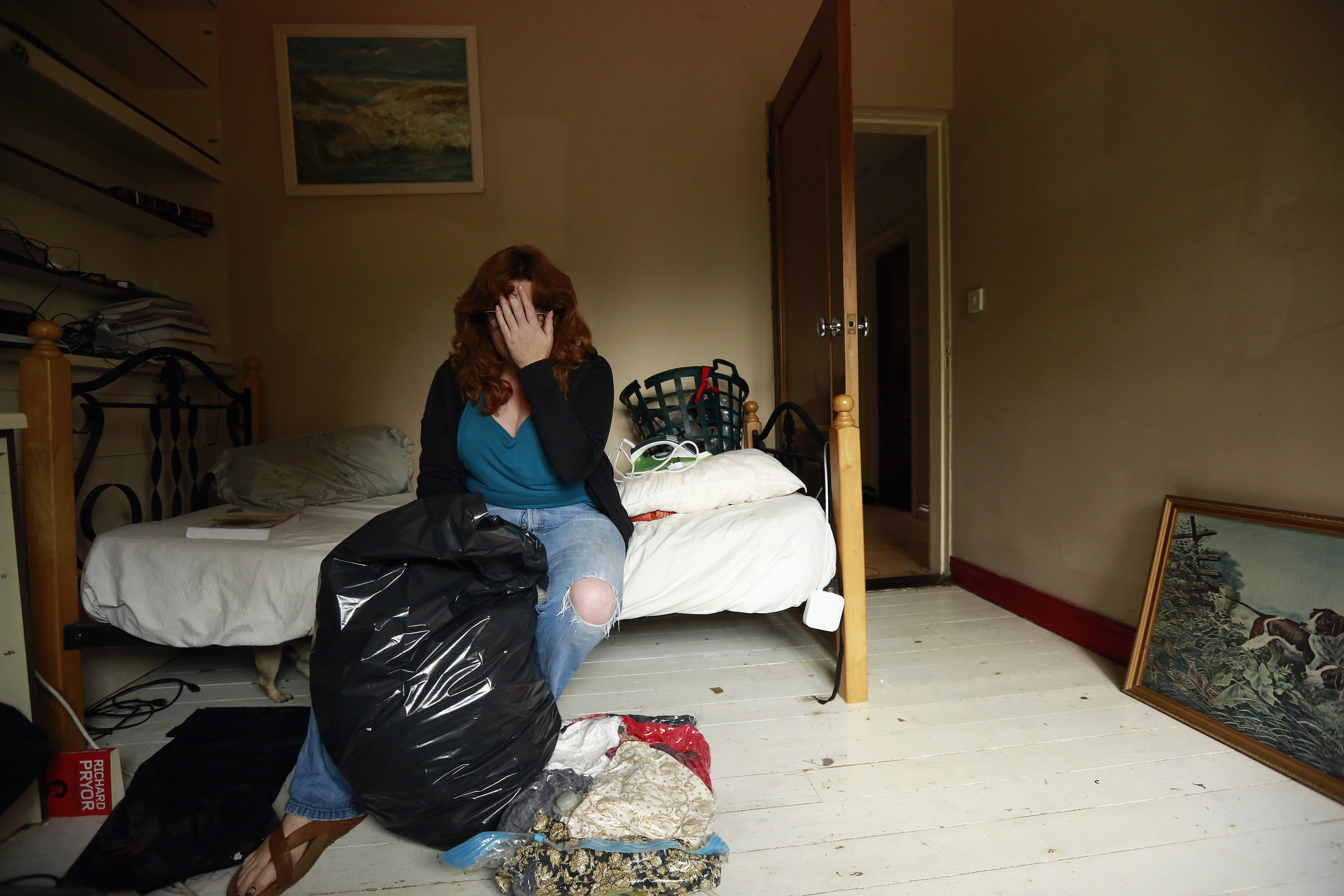 Ann Cronin reacts as she packs her belongings in preparation for her family's emigration from her hometown of Ennis in County Clare, to New Zealand September 27, 2013. Picture taken September 27. To match Insight IRELAND-BAILOUT/ REUTERS/Cathal McNaughton (IRELAND - Tags: SOCIETY IMMIGRATION BUSINESS EMPLOYMENT)