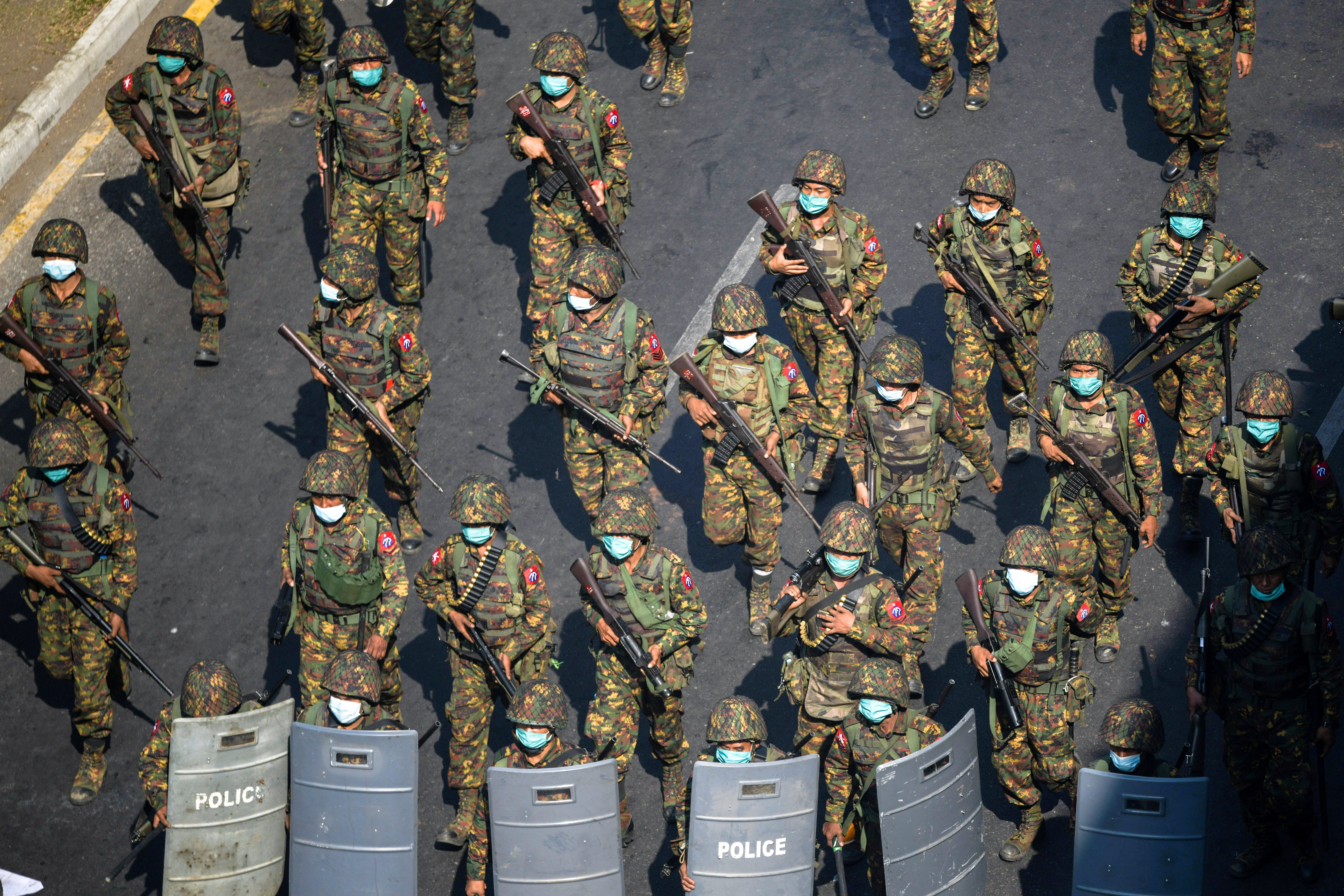 Myanmar soldiers are seen patrolling a street in Yangon