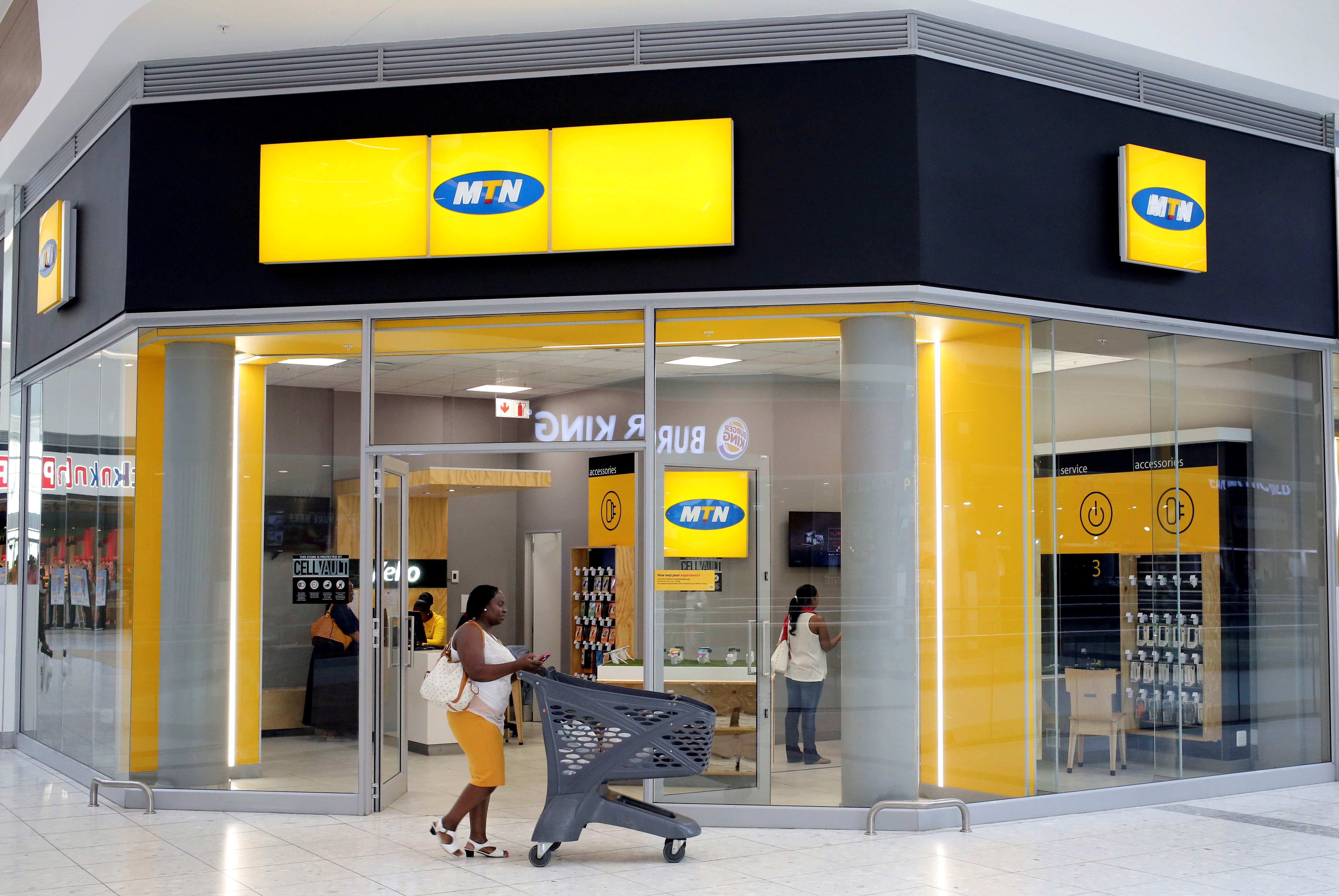 A shopper walks past an MTN shop at a mall in Johannesburg, South Africa