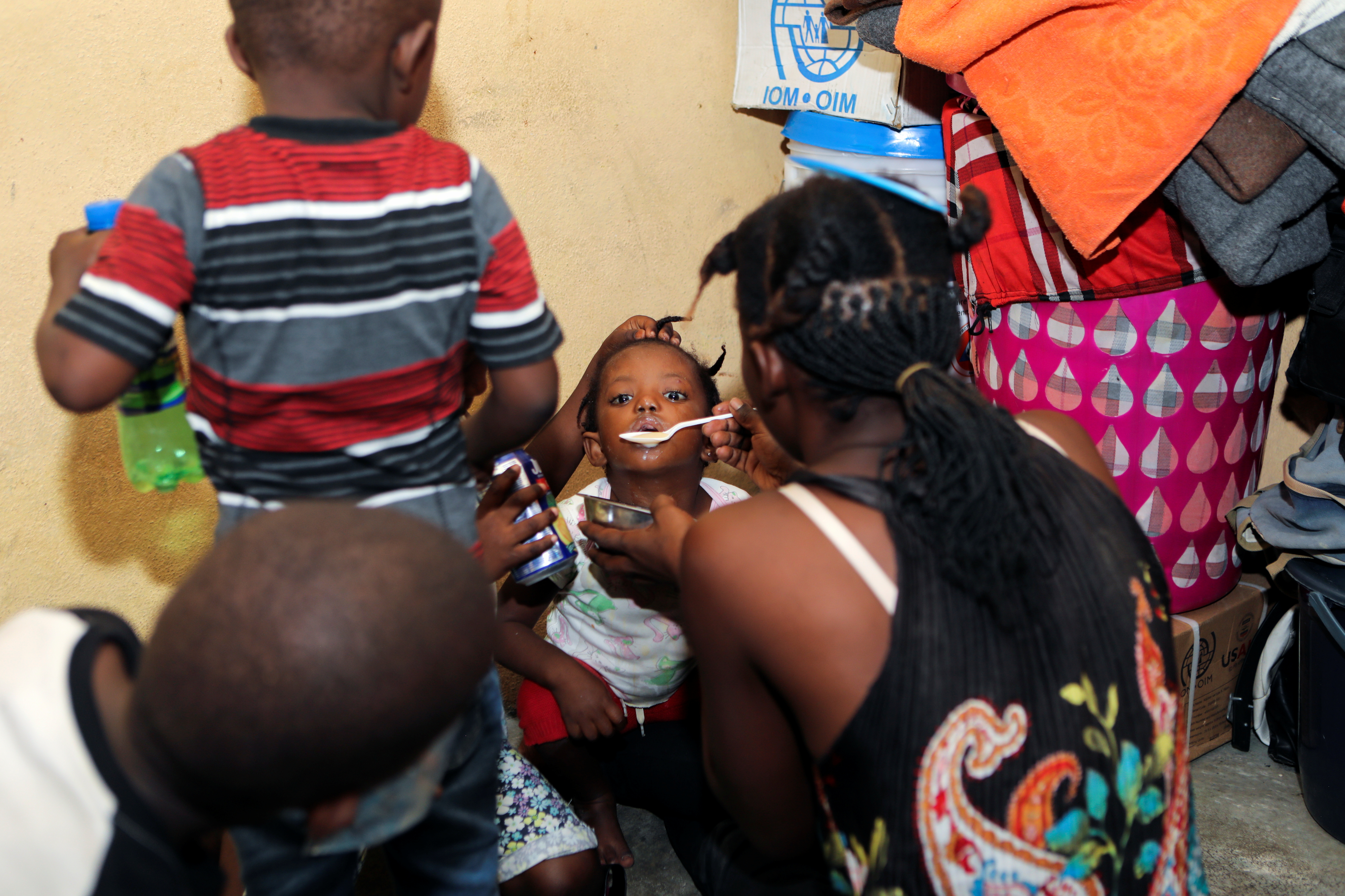 A boy eats in a school that serves as a shelter in Haiti