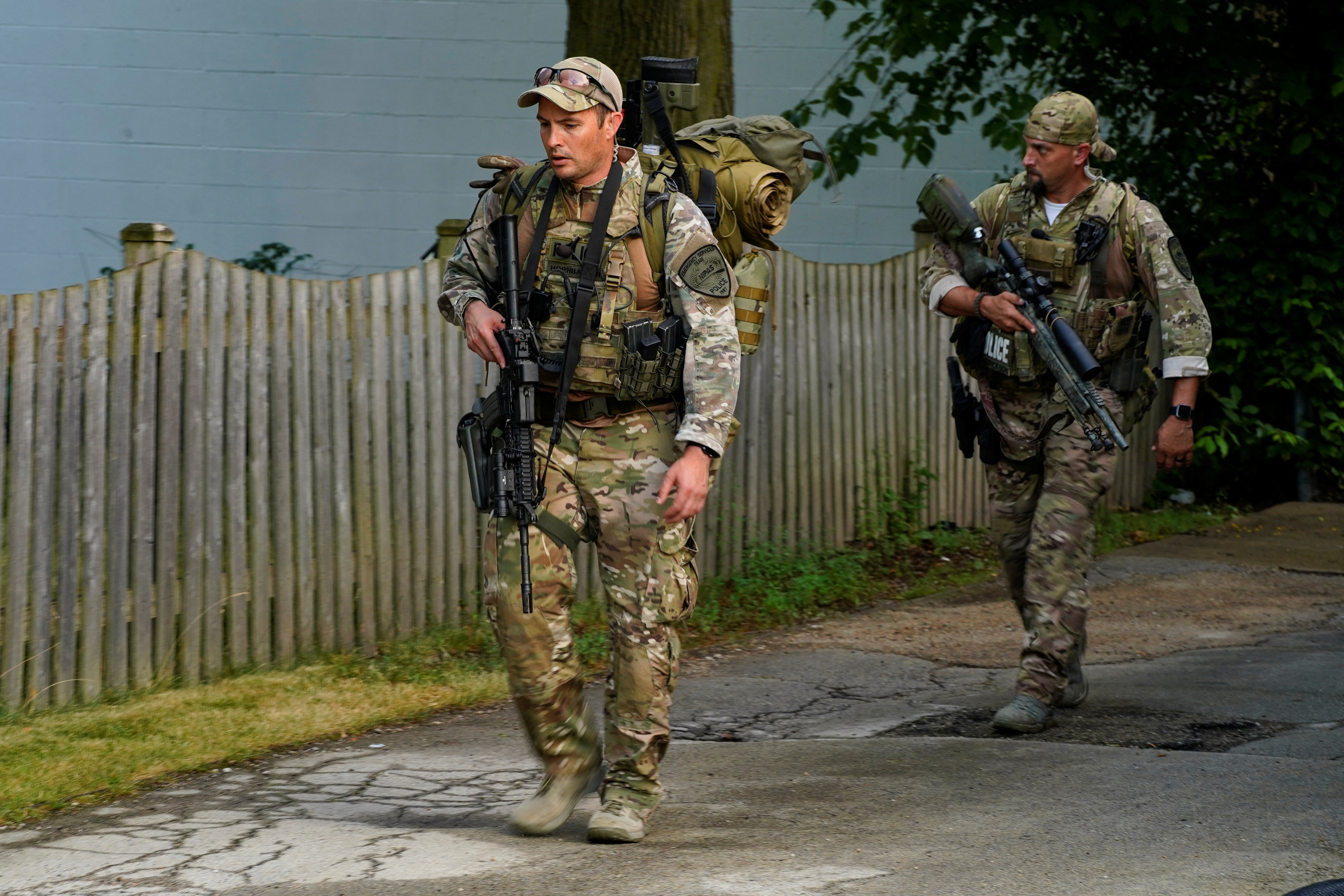 Police investigate outside the home of the mother of the man detained