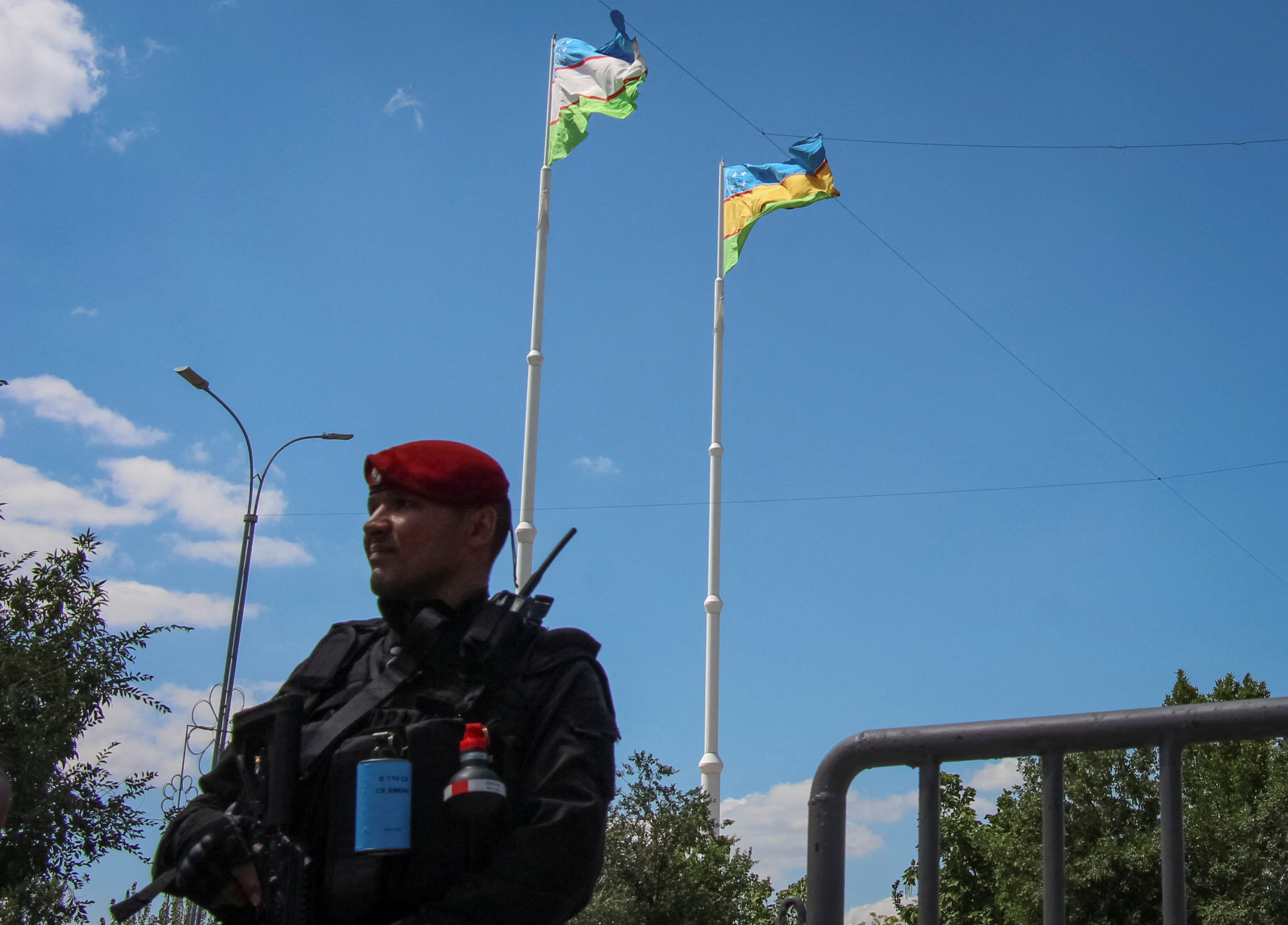 An Uzbek service member guards a road during a government-organised press visit in Nukus, capital of the northwestern Karakalpakstan region,