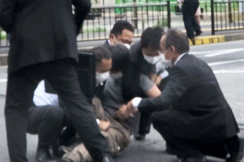This screen grab shows a man being detained near the location where former Japanese Prime Minister Shinzo Abe was shot in Nara