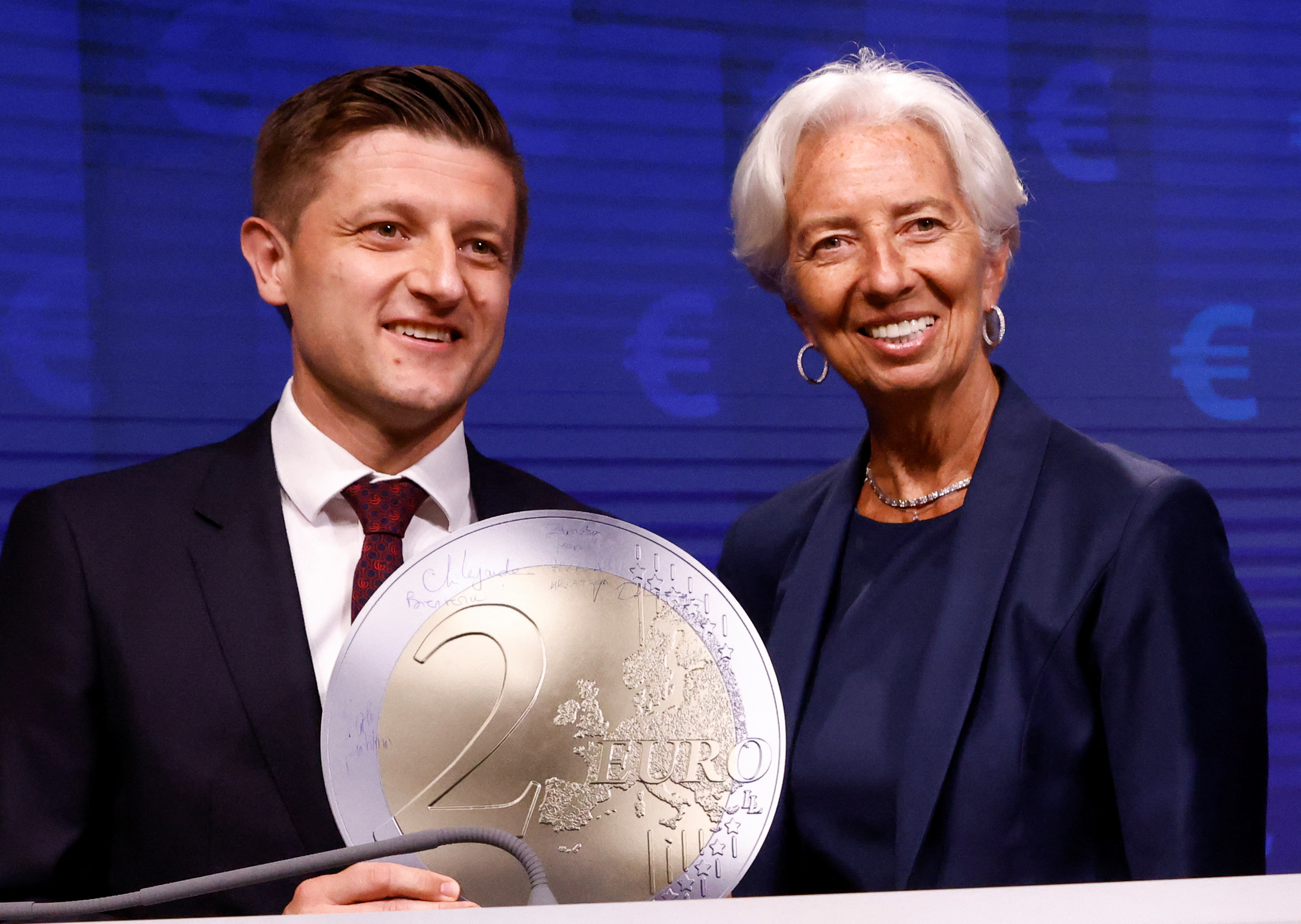 Croatia's Finance Minister Marko Primorac and President of European Central Bank Christine Lagarde pose with a model of a Euro coin