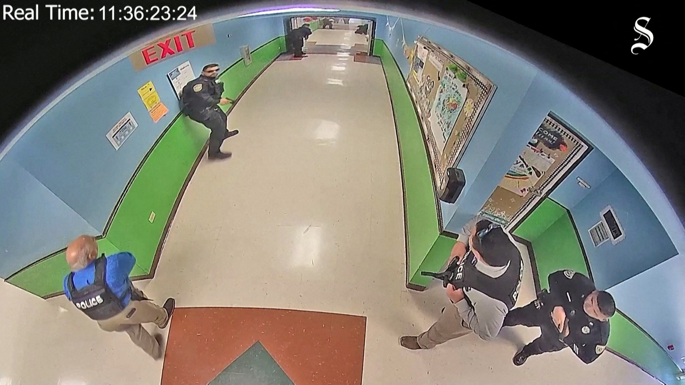 Police arrive to search hallways after Salvador Ramos entered Robb Elementary school to kill 19 children and two teachers in Uvalde, Texas, U.S. May 24, 2022 in a still image from school surveillance video obtained by the Austin American-Statesman newspaper. Austin American-Statesman/Handout via REUTERS. NO RESALES. NO ARCHIVES. MANDATORY CREDIT