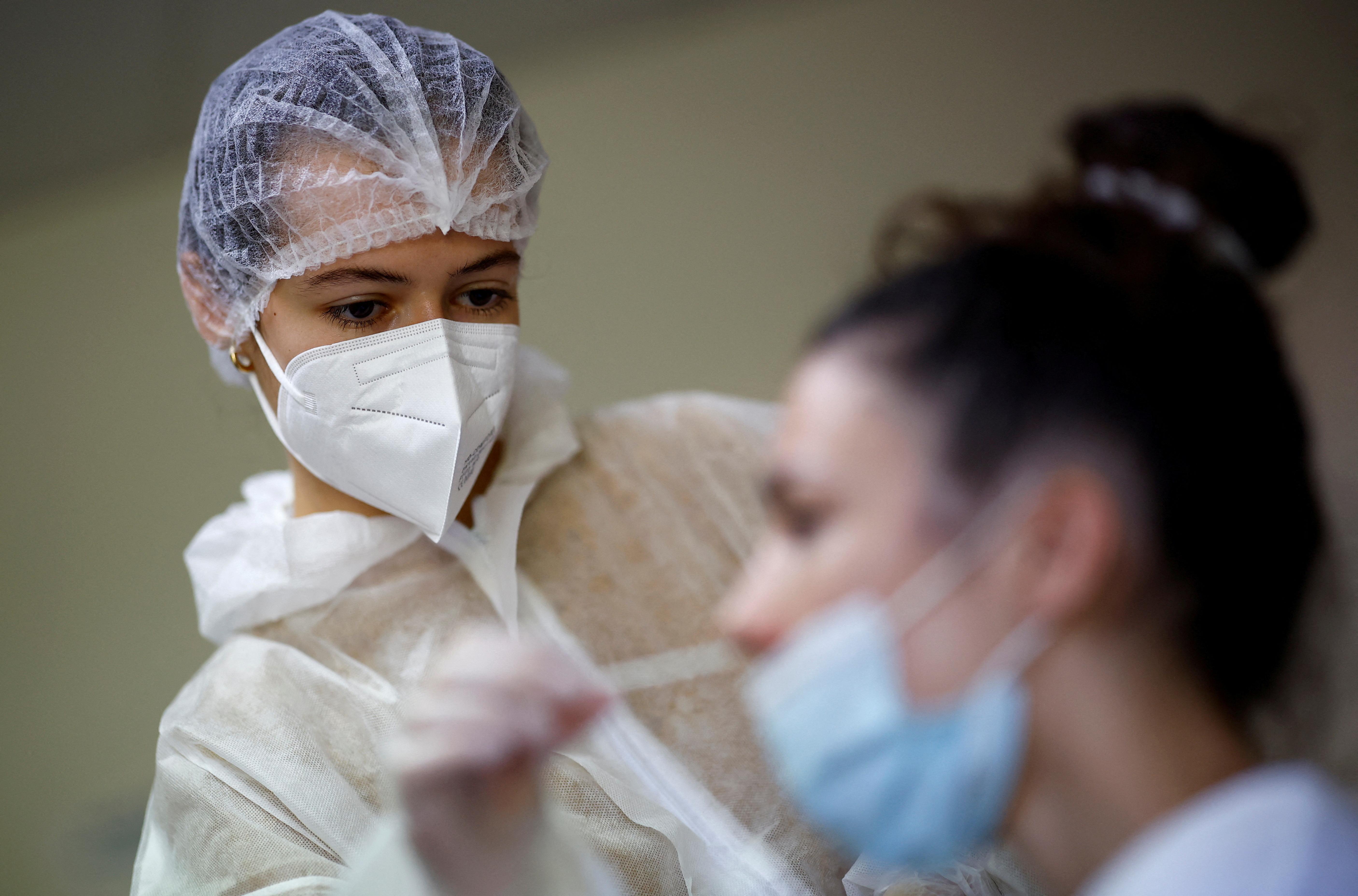 A medical worker administers a nasal swab to a patient at a COVID testing centre in Les Sorinieres, near Nantes, France.