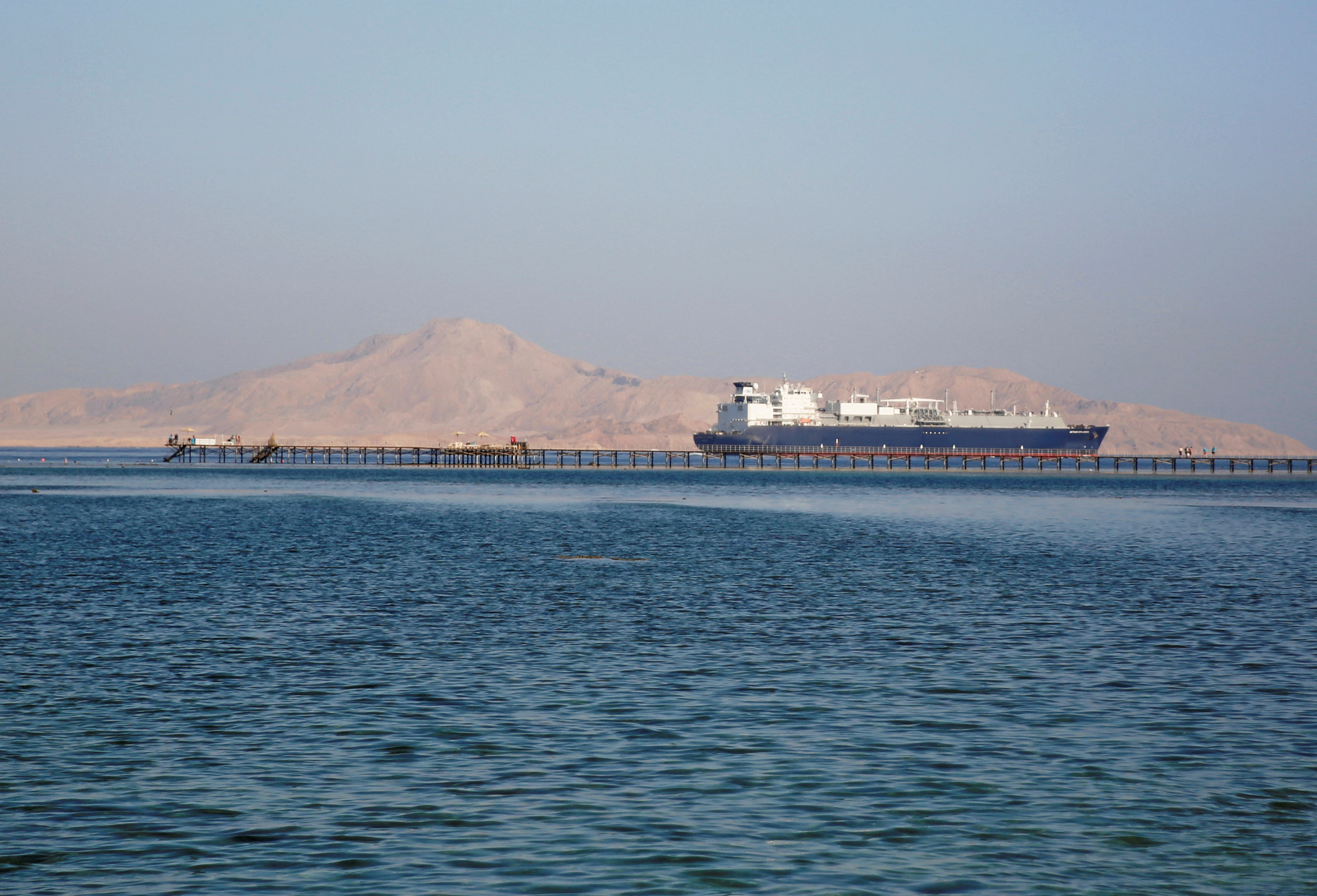 A container ship passes in front of Tiran Island