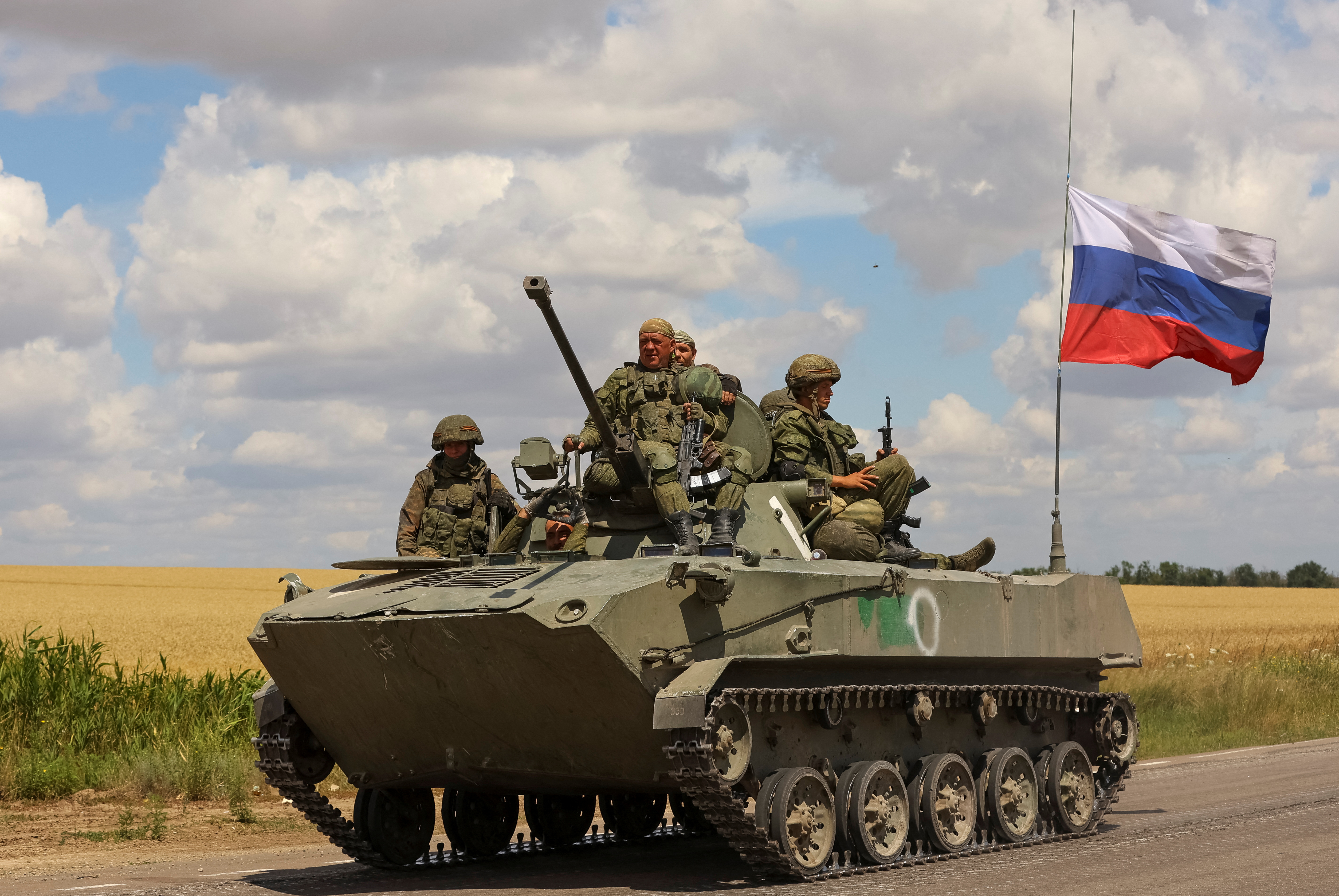 Service members of Russian troops ride on top an armoured vehicle in Russian-held part of Zaporizhzhia region, Ukraine, July 23, 2022. REUTERS/Alexander Ermochenko