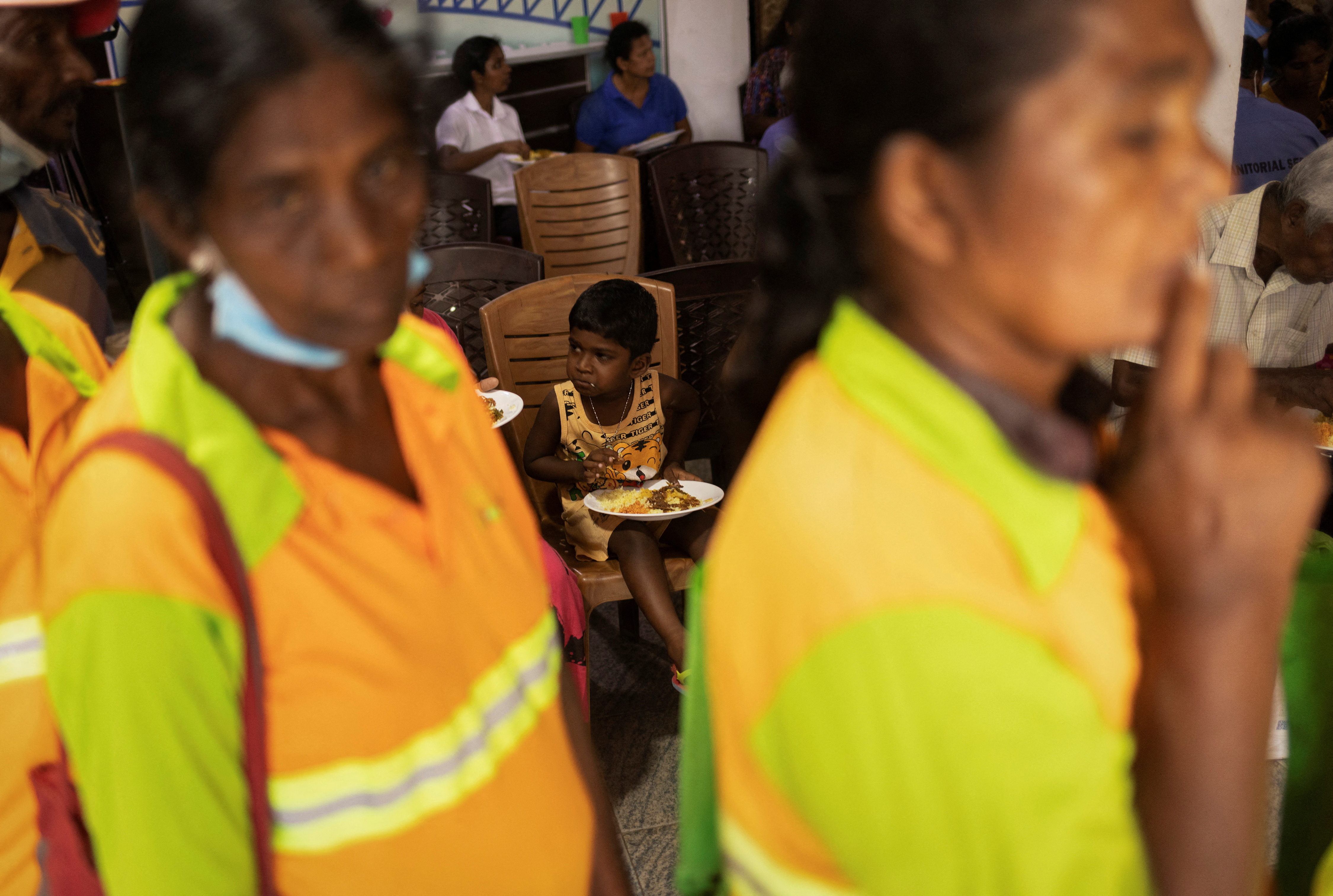 People eat at a community kitchen