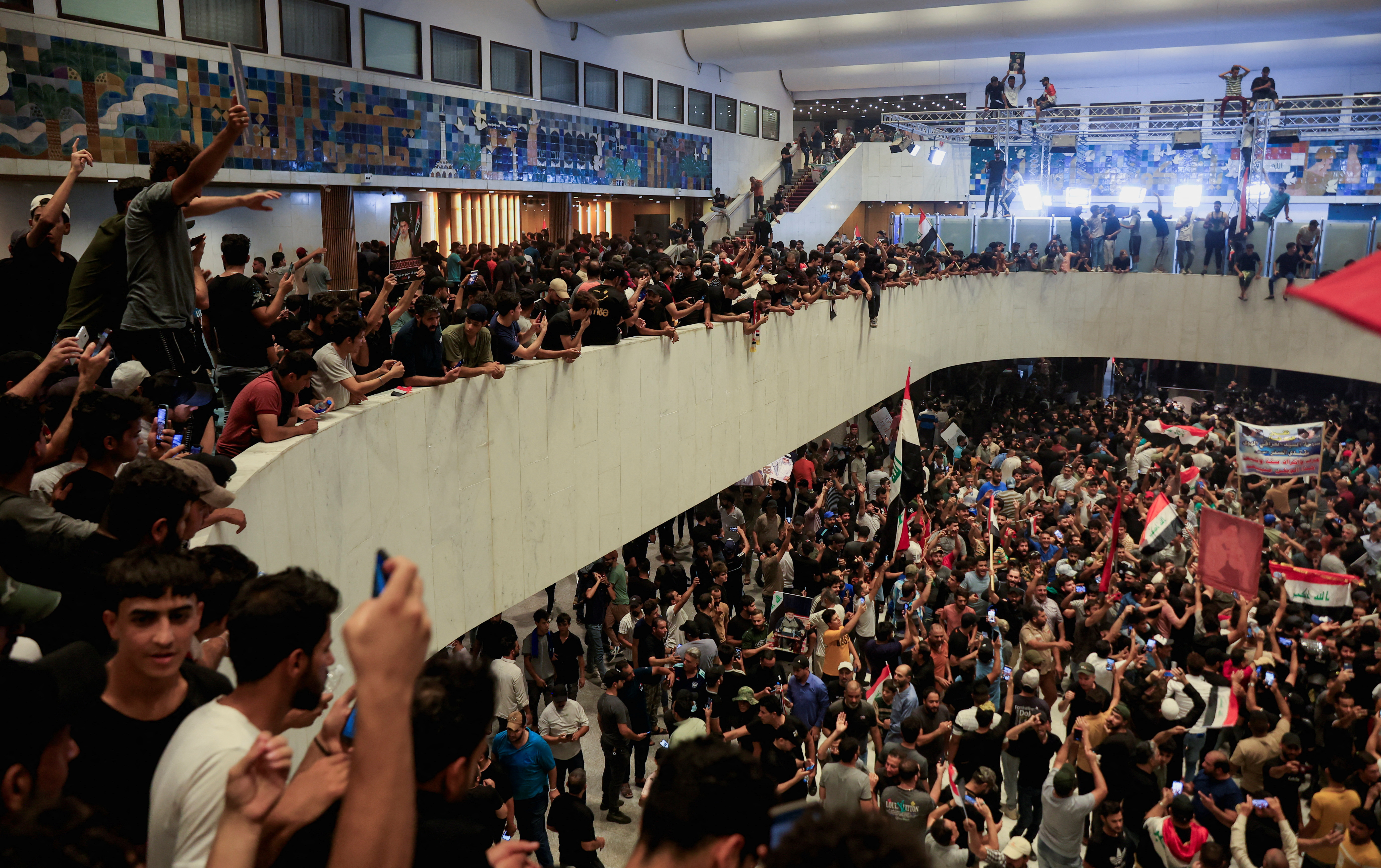 Supporters of Iraqi Shi'ite cleric Moqtada al-Sadr protest against corruption inside the parliament building