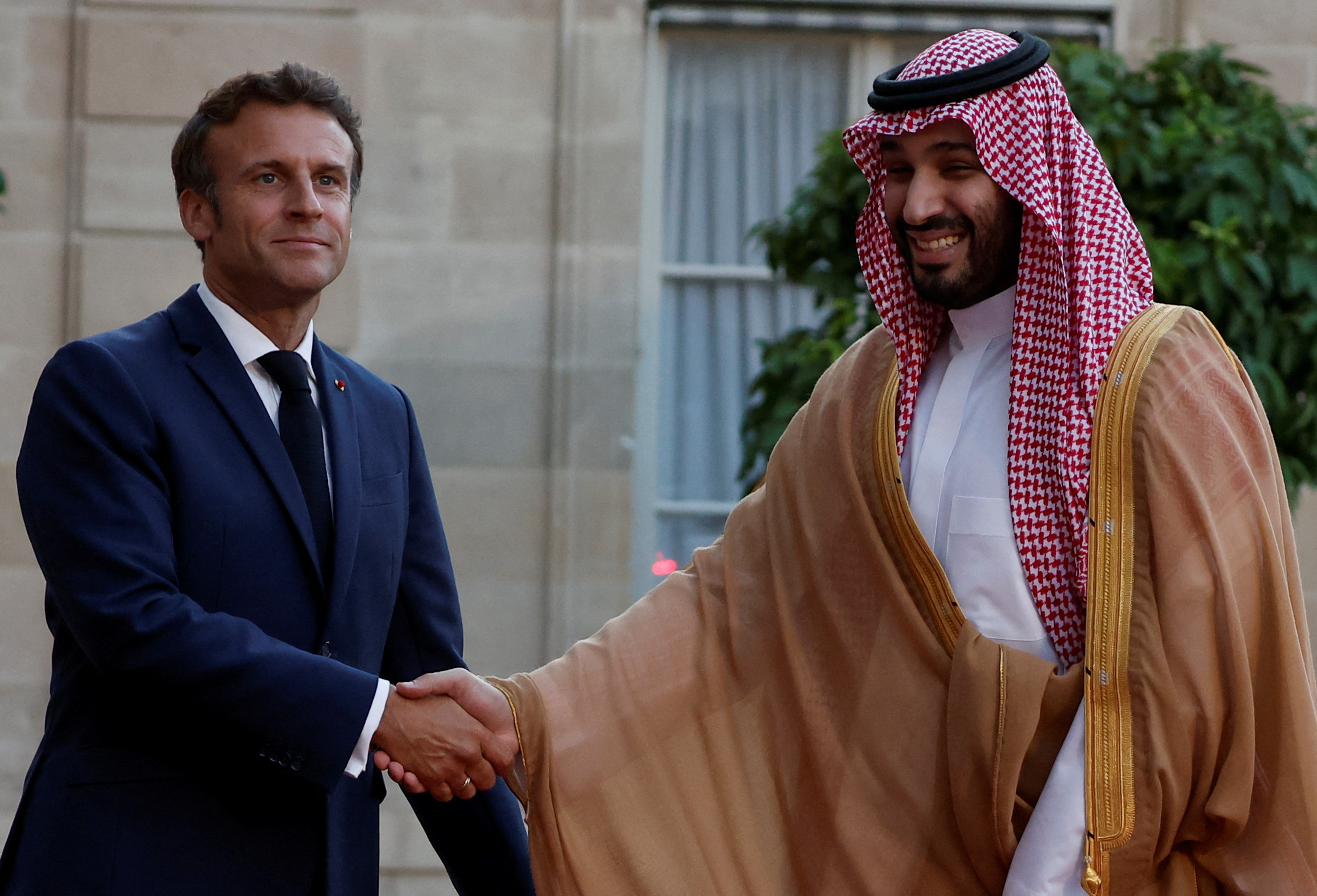 French President Emmanuel Macron and Saudi Crown Prince Mohammed bin Salman shake hands at the Elysee Palace in Paris.