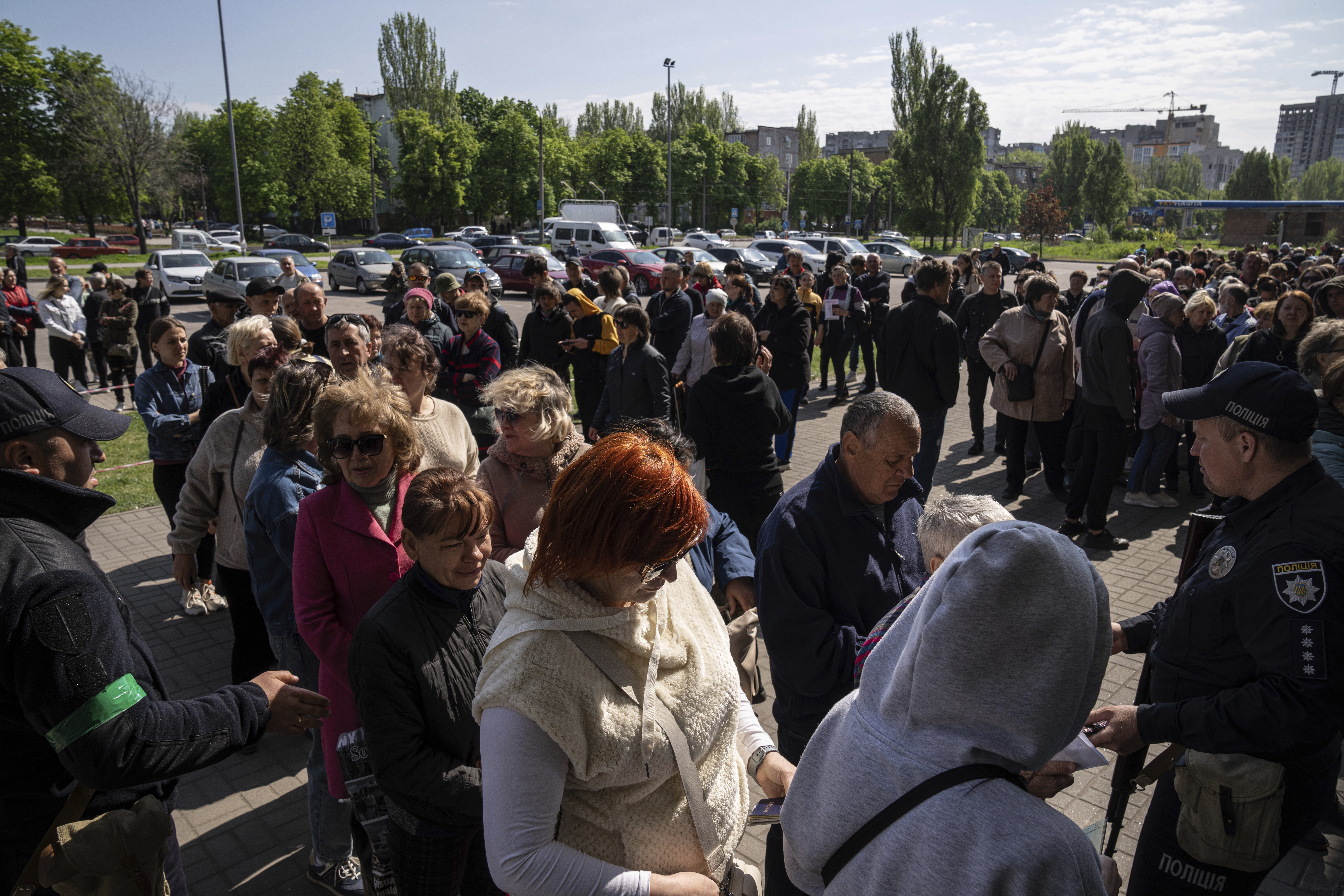 People stand in line for registration at the aid distribution center for displaced people in Zaporizhia, Ukraine