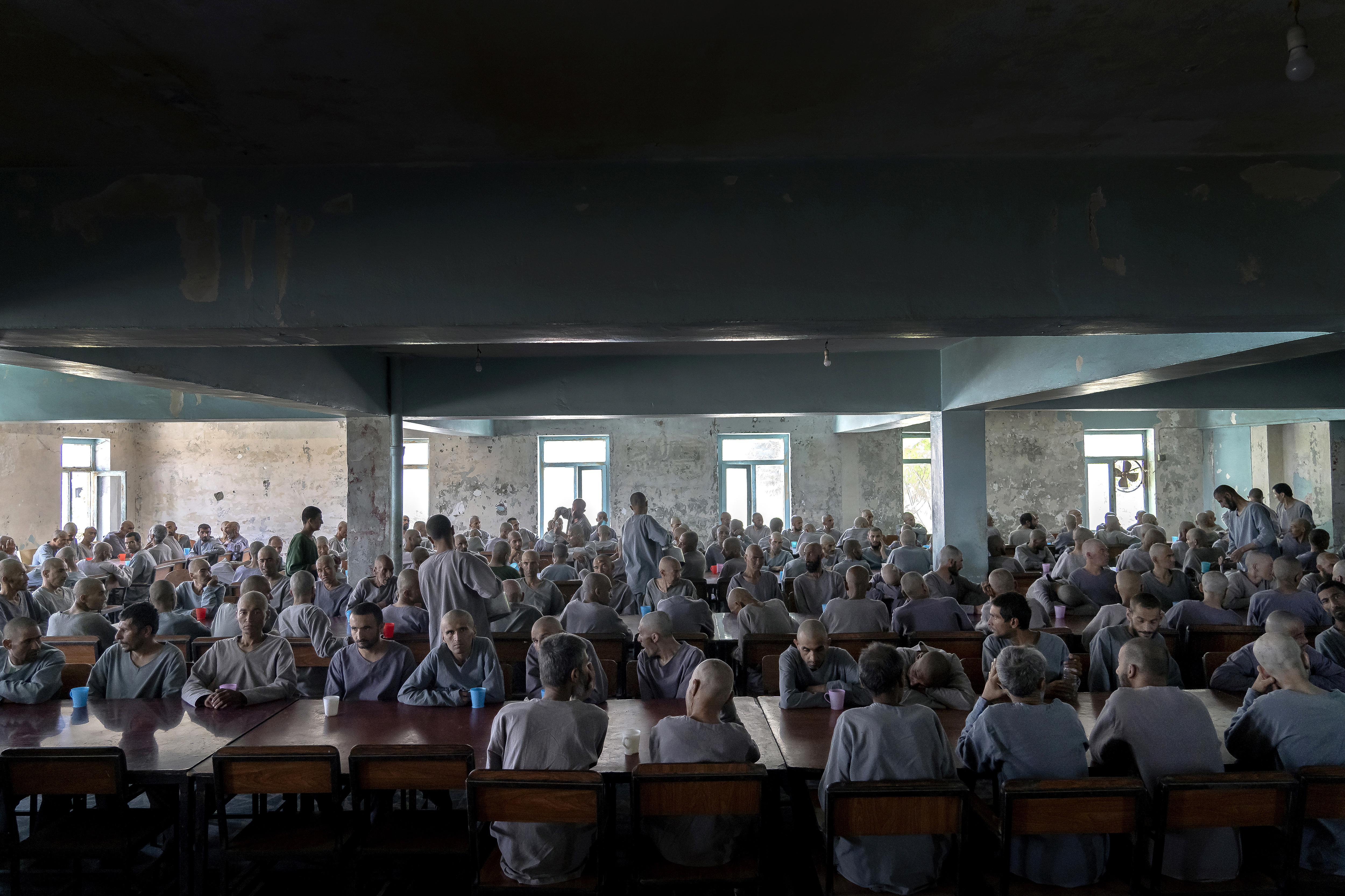 Drug addicts undergoing treatment eat in a dining hall