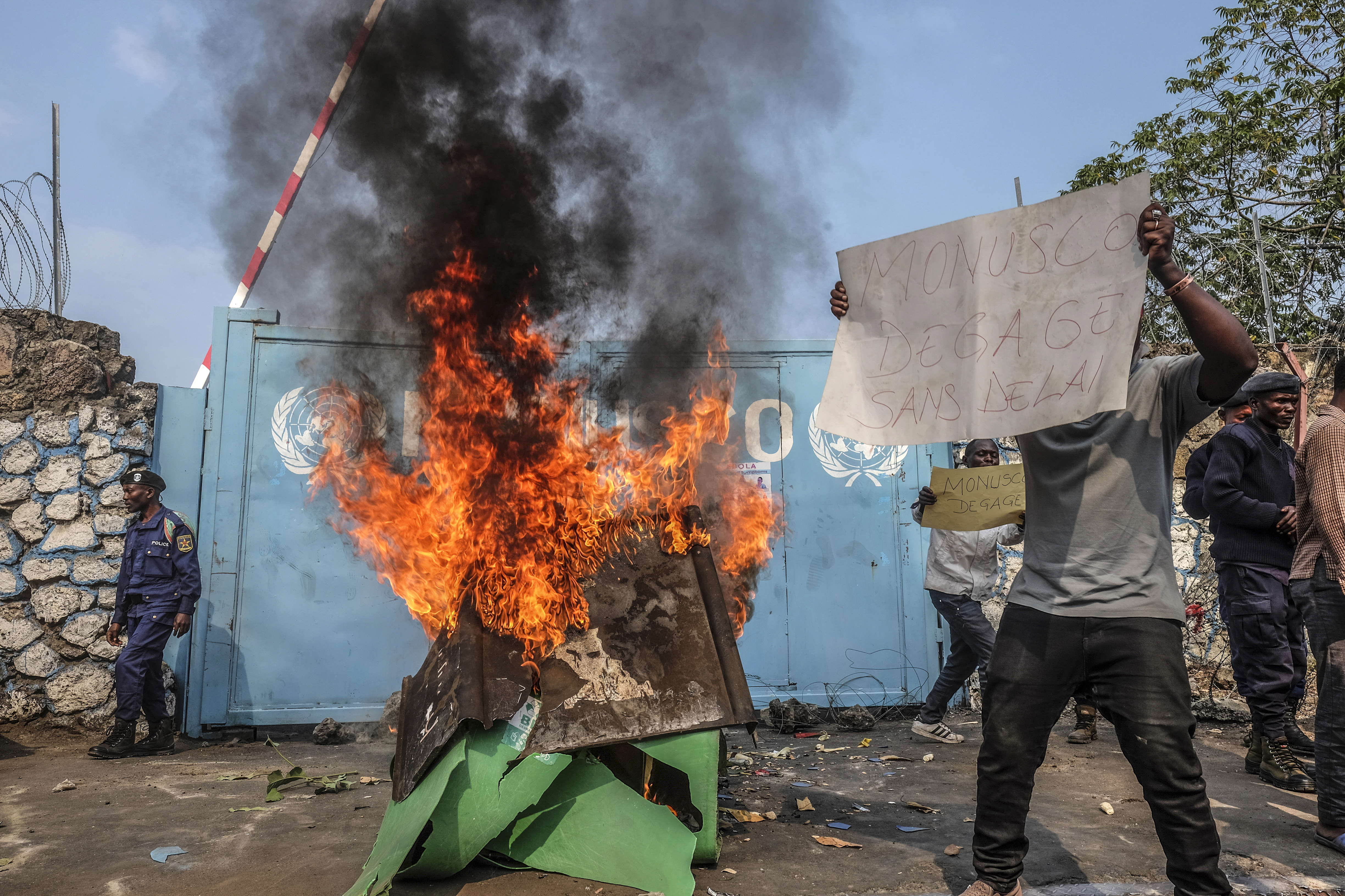 A resident holds a placard reading ''MONUSCO get out without delay'' as they protest against the United Nations peacekeeping force (MONUSCO) deployed in the Democratic Republic of the Congo, in Goma