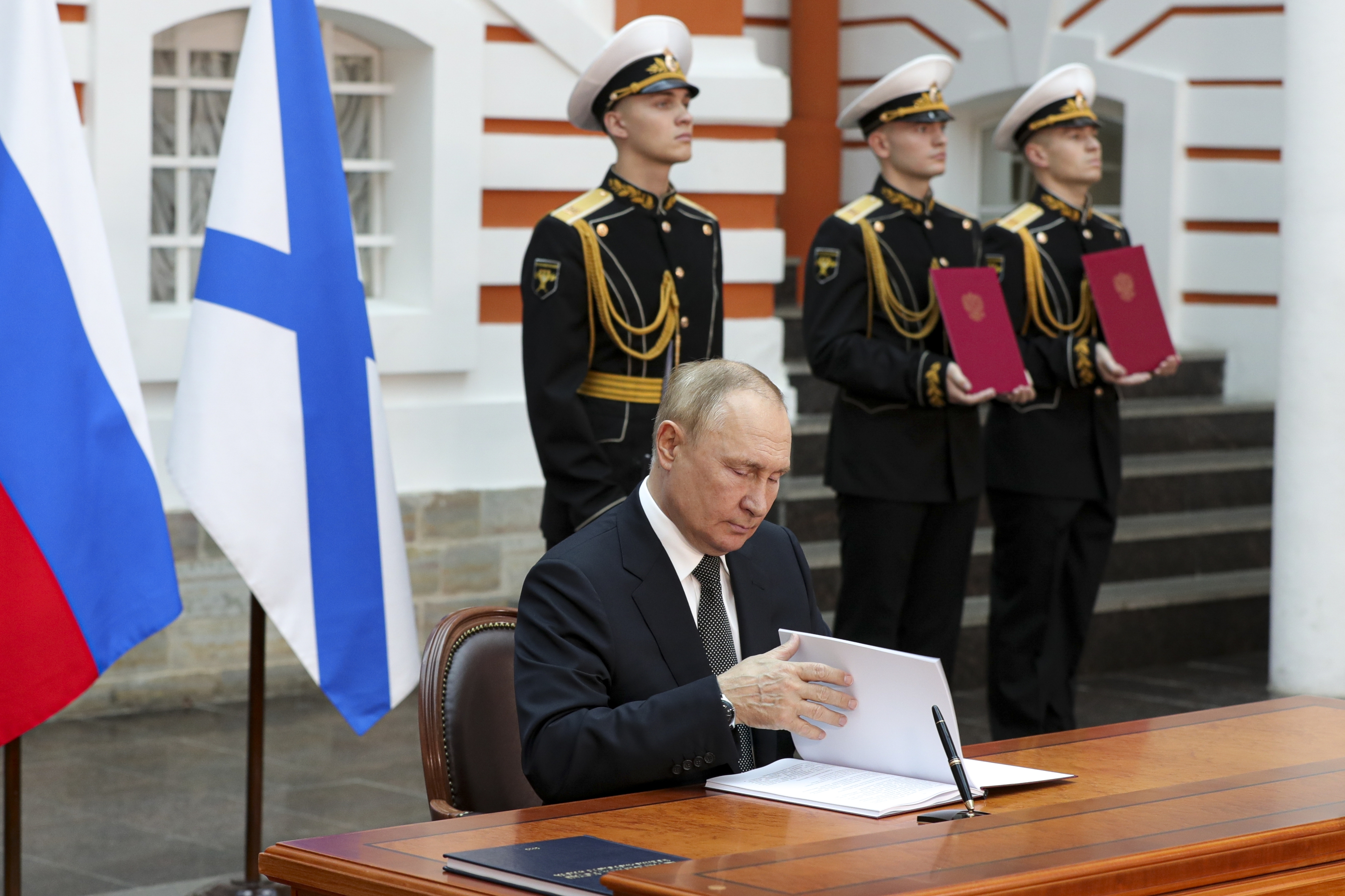 Russian President Vladimir Putin signs the decrees approving the Naval Doctrine and the Ship Charter of the Russian Navy in the St. Petersburg State History Museum at the Peter and Paul Fortress before the main naval parade marking Russian Navy Day