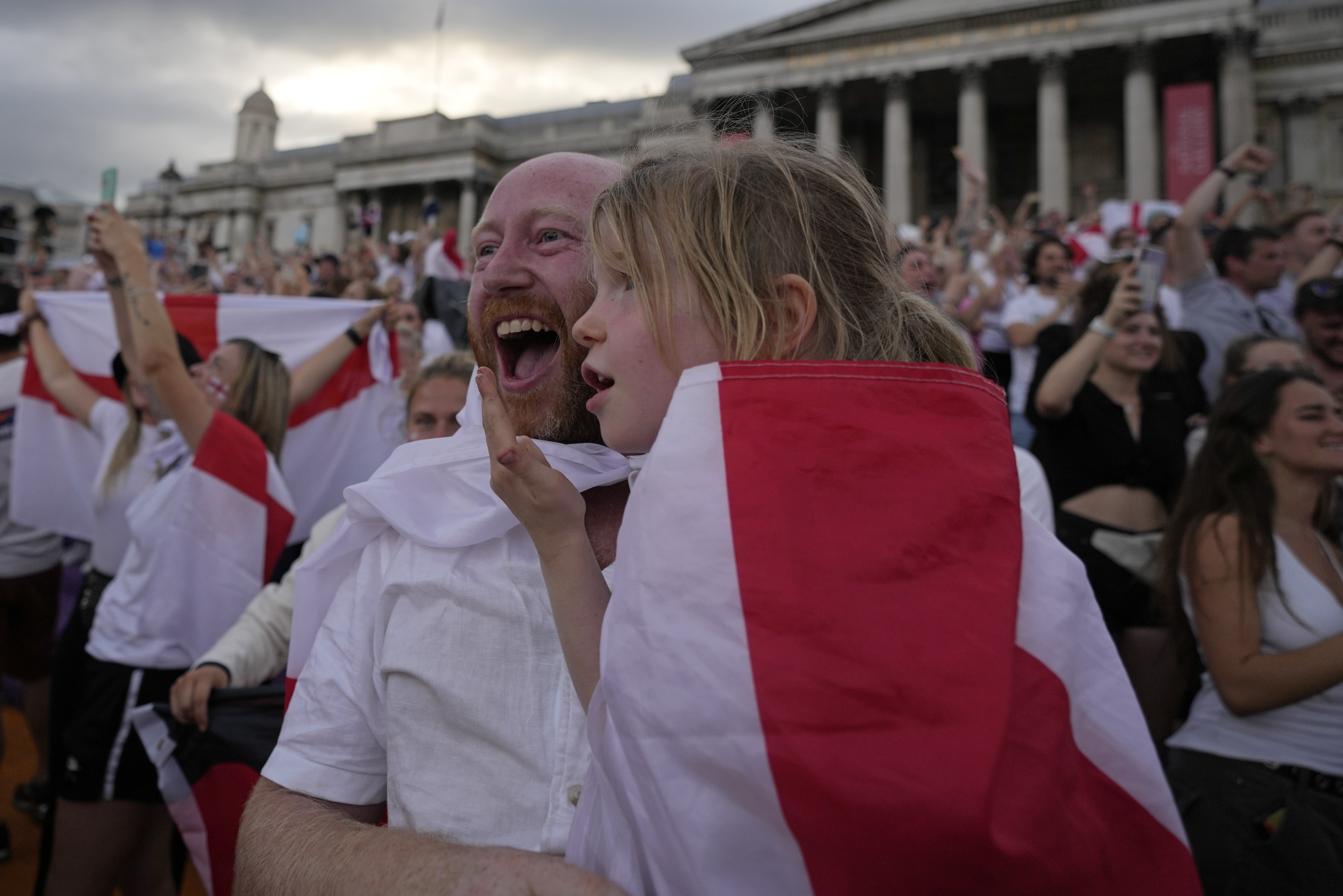 England supporters celebrate in Trafalgar Square after watching their team win the final of the Women's Euro 2022 soccer match between England and Germany being played at Wembley stadium in London, Sunday, July 31, 2022. (AP Photo/Frank Augstein)