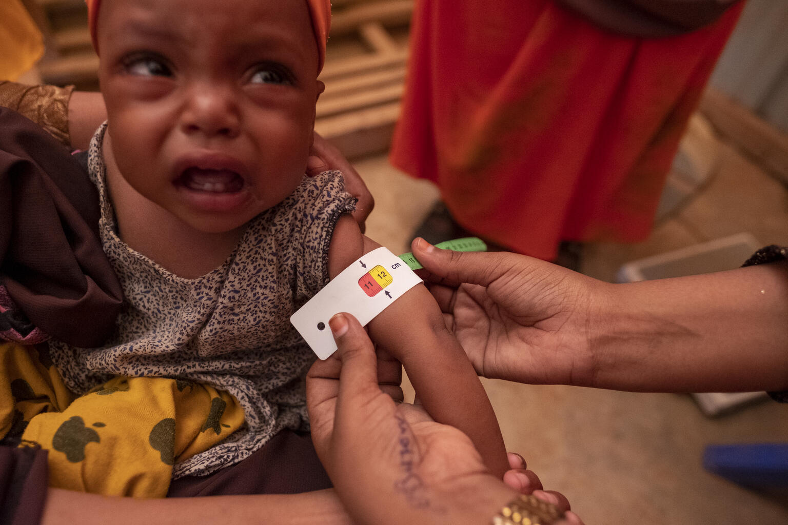 A child is given a health check The Kabasa IDP Center