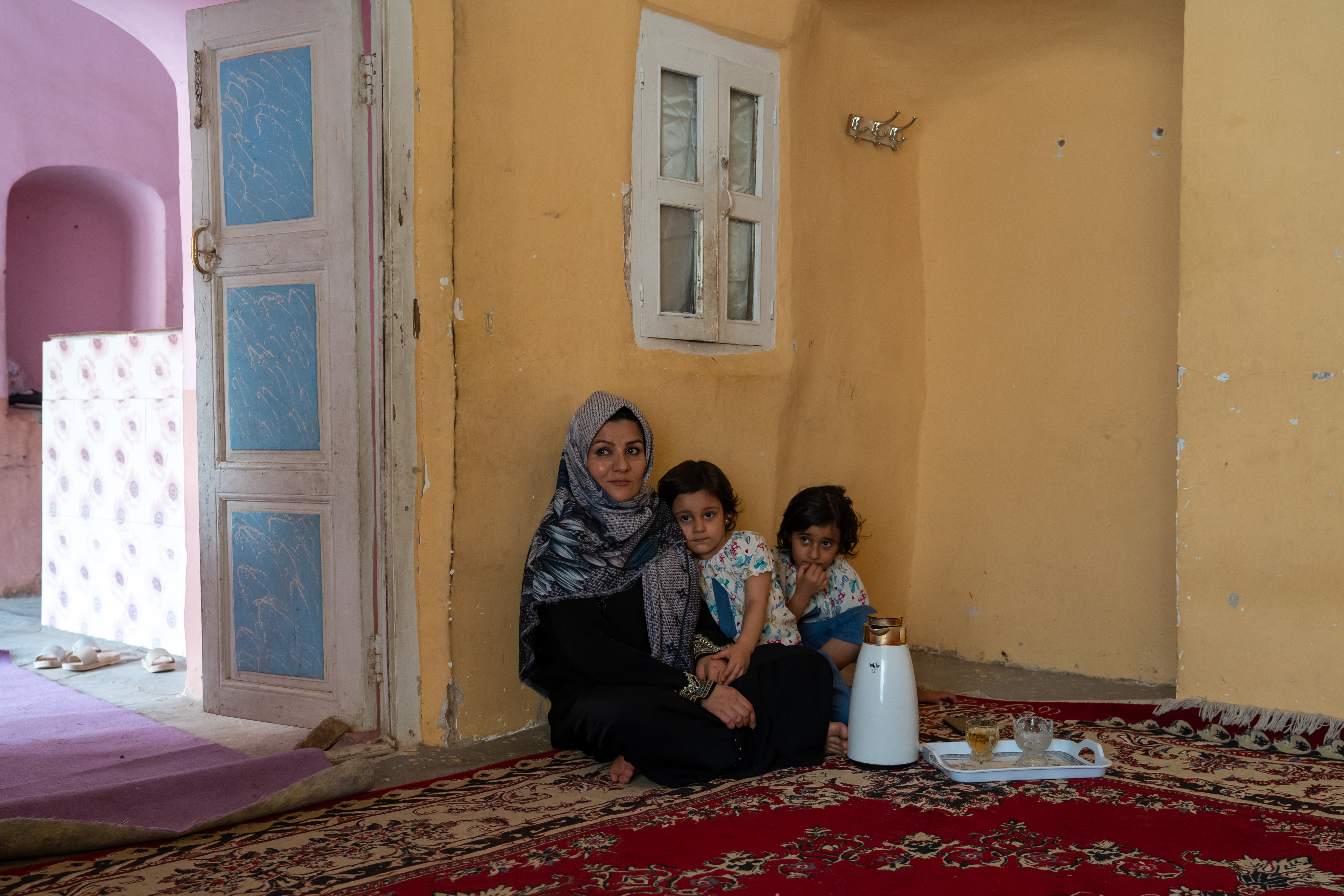 An Afghan mother and her two small daughers