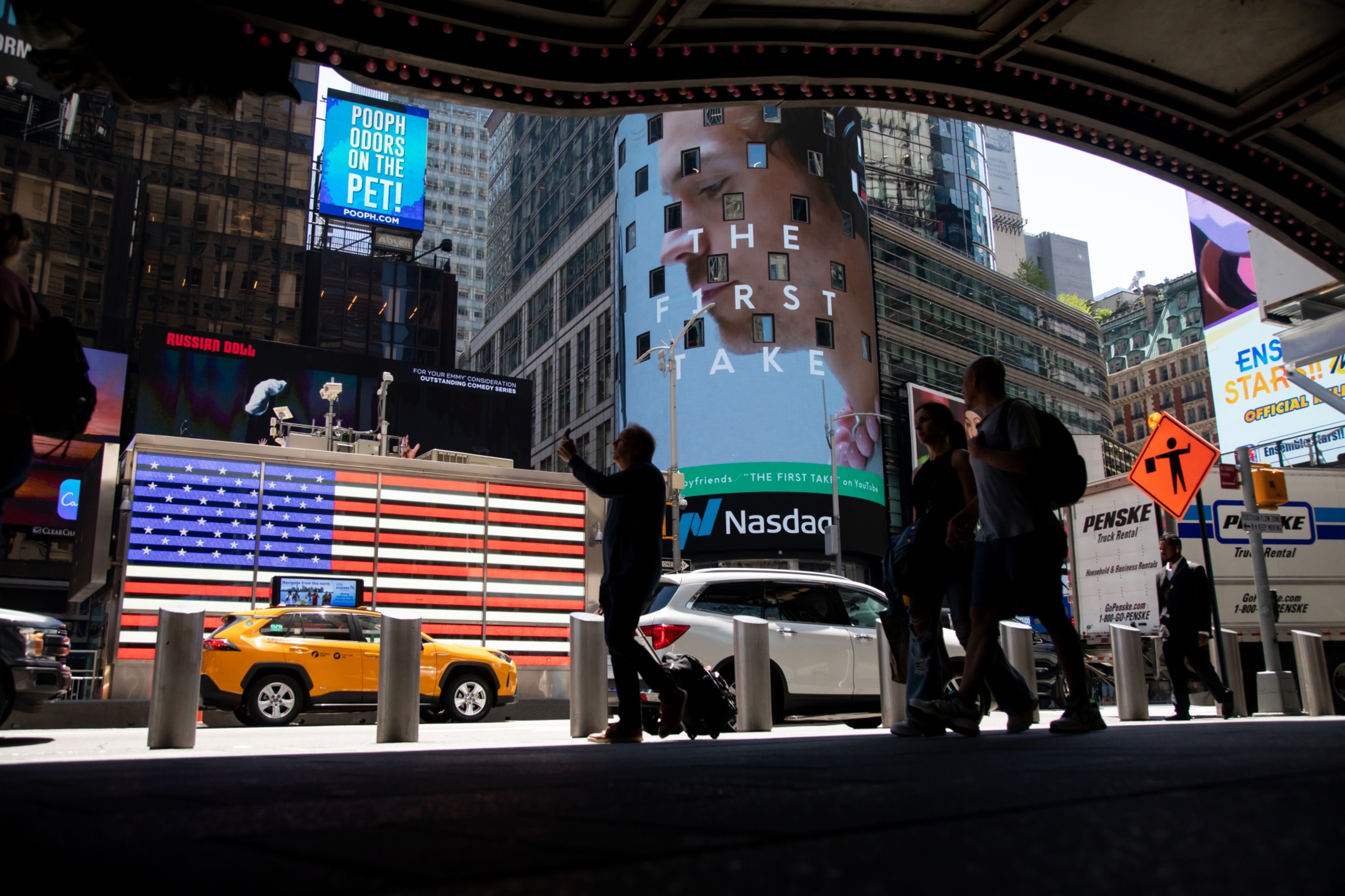 Pedestrians in front of the Nasdaq MarketSite in New York, US