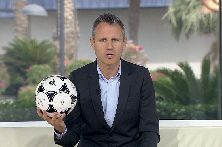 A photo of a man holding a football.