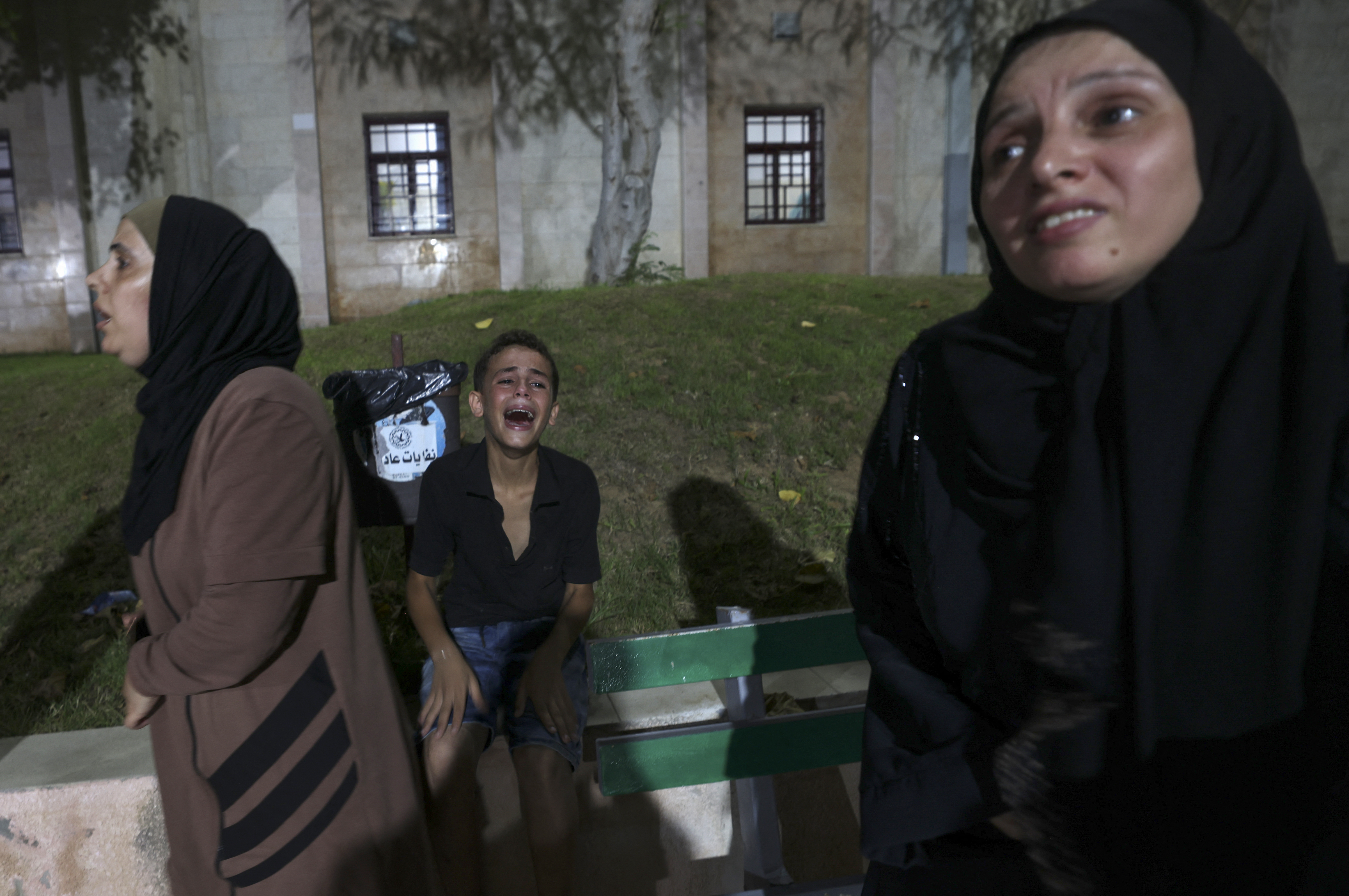Palestinians react at a hospital in Jabalia refugee camp